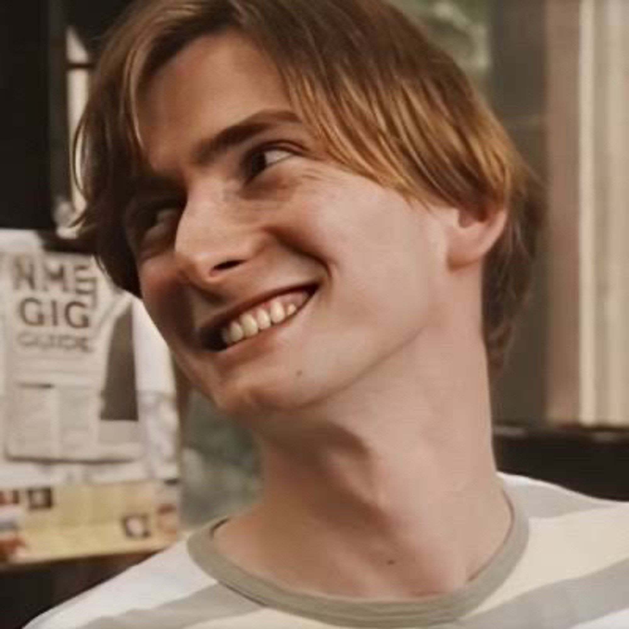 Young David Tennant as Campbell Bain. His hair is straight, brown and has blond lights. He looking sideways, smiling, and is crinkling his eyes on an adorable expression