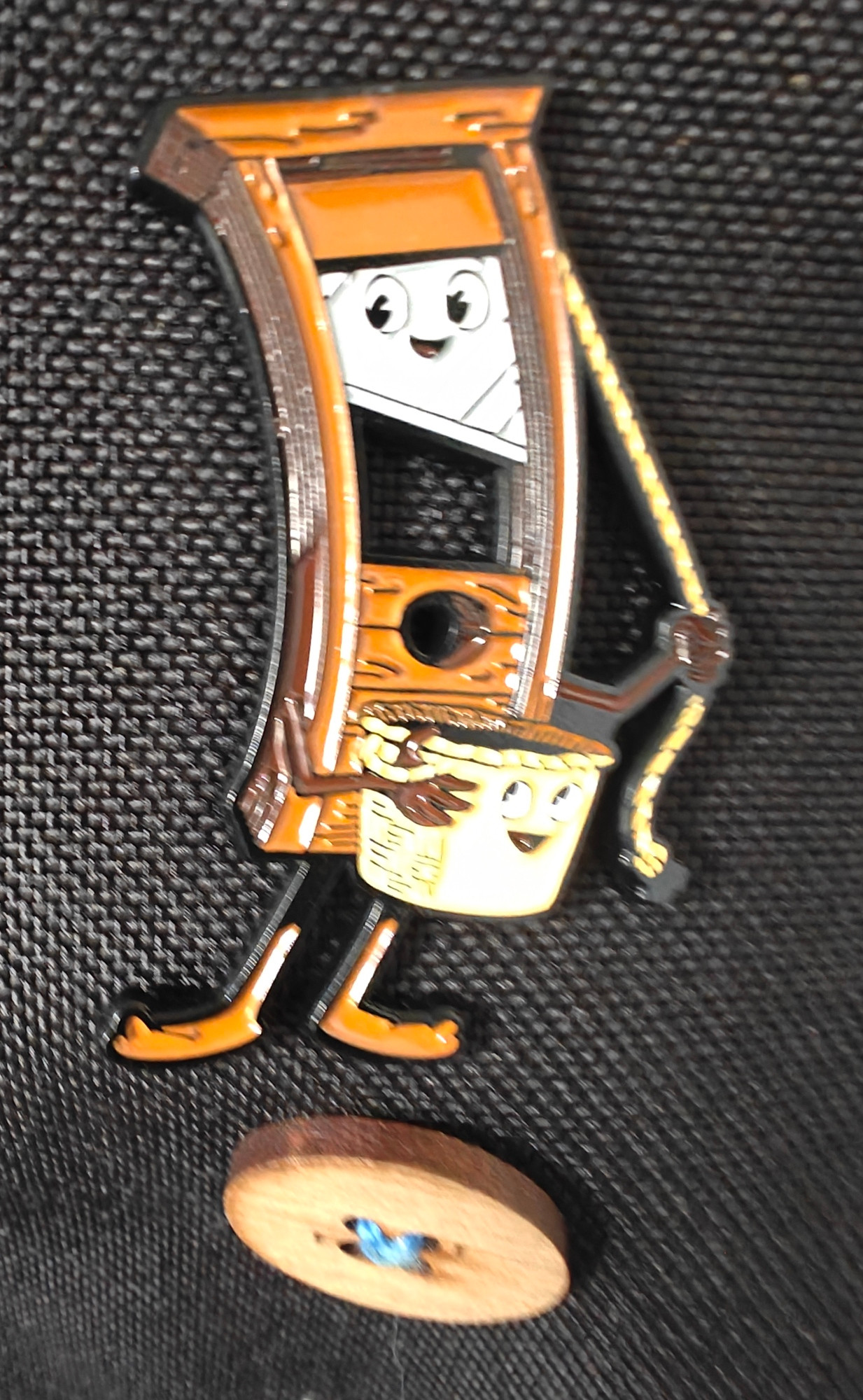 Gilly the guillotine badge on a @weare1of100 bag