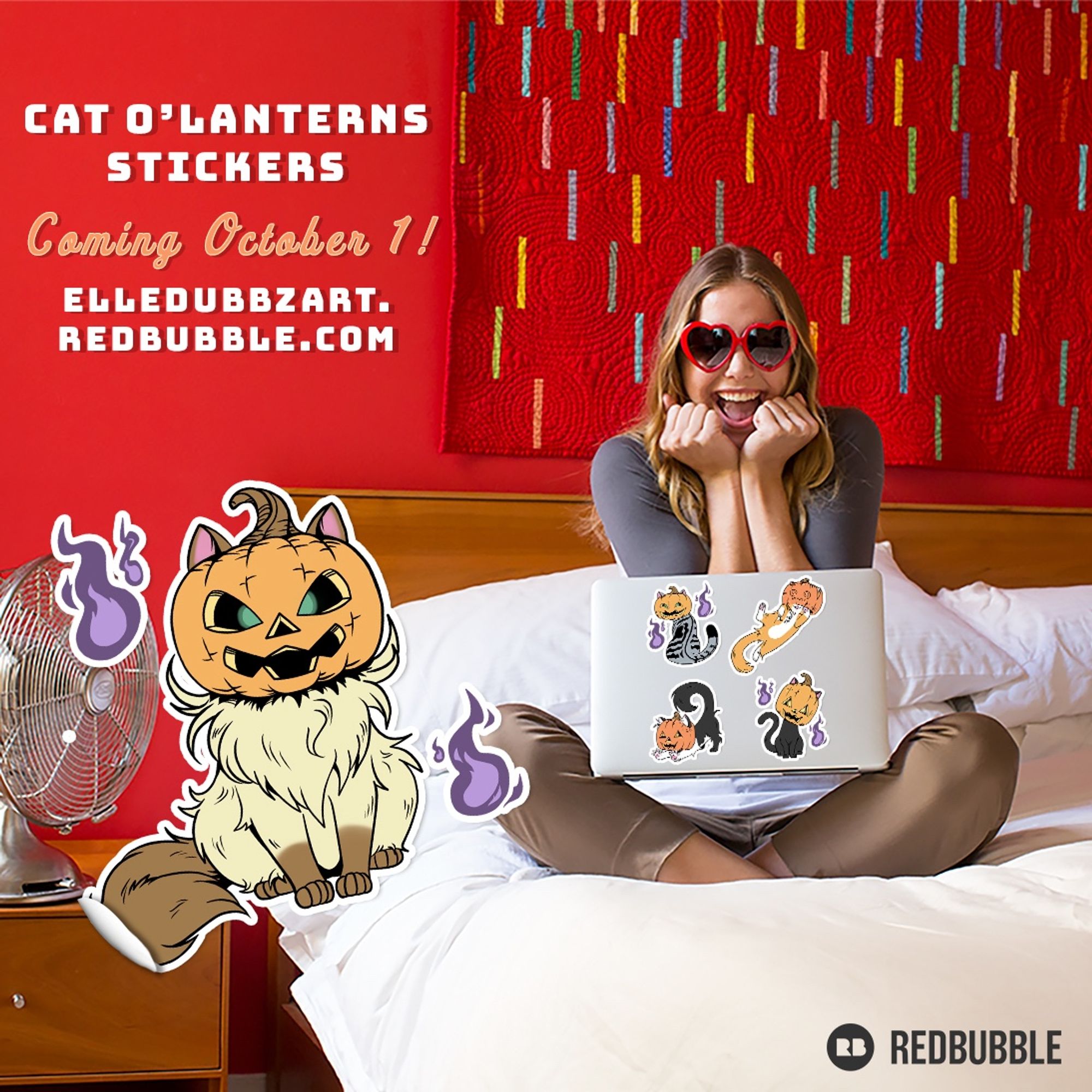 An excited woman with red heart sunglasses sitting cross-legged on a bed with a laptop on her lap. The laptop has cat o'lantern stickers. The text reads "Cat O'Lantern Stickers Coming October 1st! Elledubbz.redbubble.com"