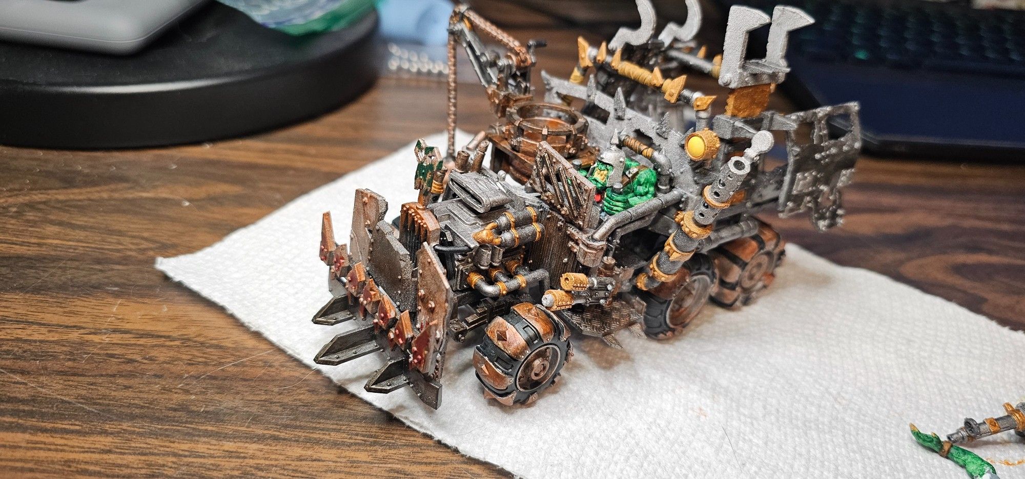 Warhammer 40k Ork Trukk oblique driver side, with brown built up over some of the orange rust on the front wheels, and outside of the cabin