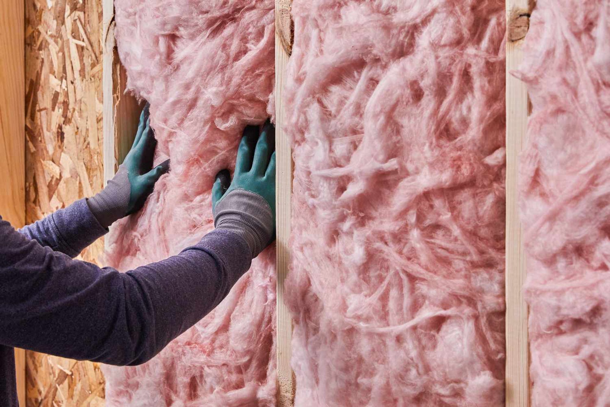 pink colored insulation being installed