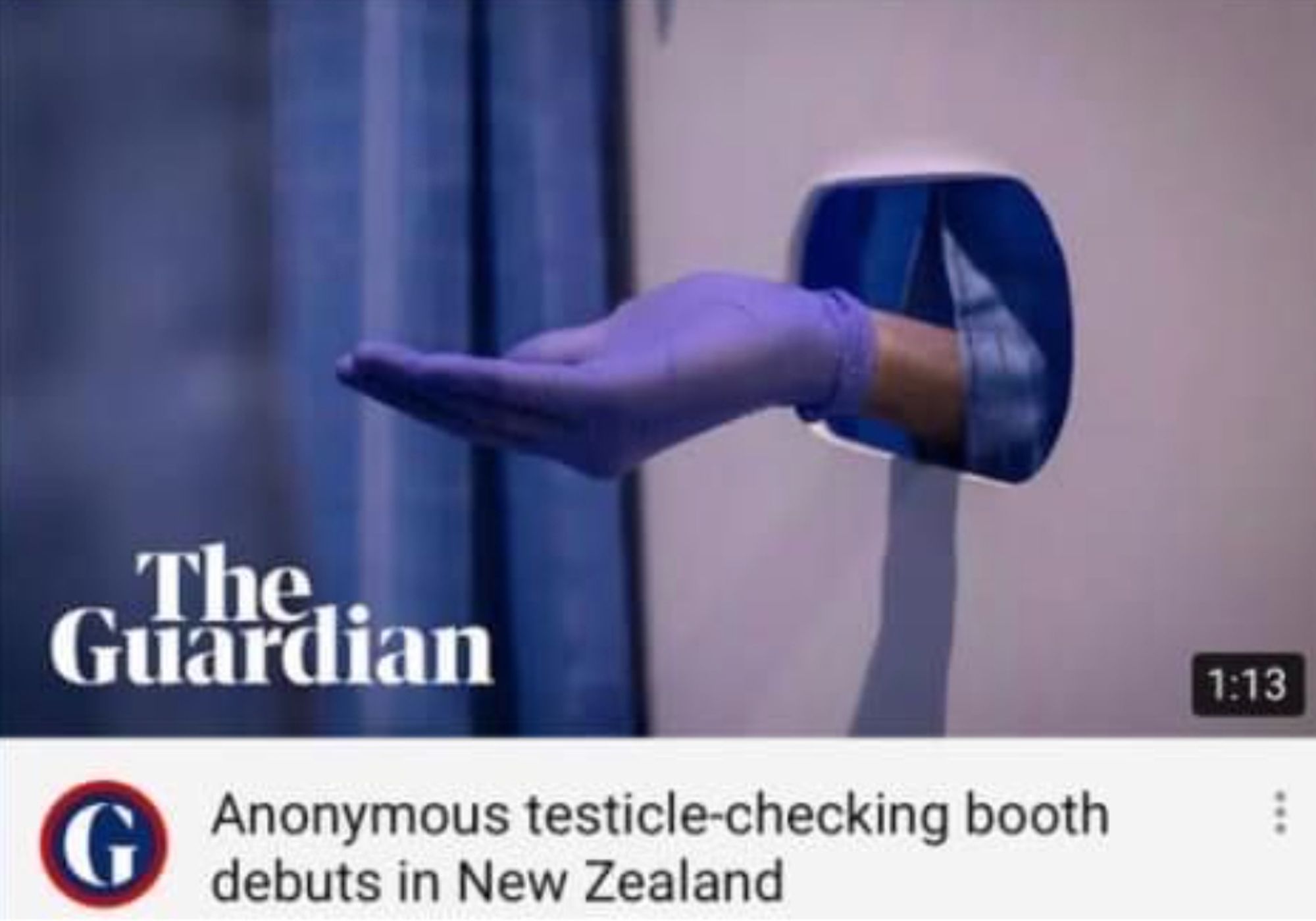 a hand with a medical glove sticking out of a hole in a wall

headline says: anonymous testicle-checking booth debuts in New Zealand