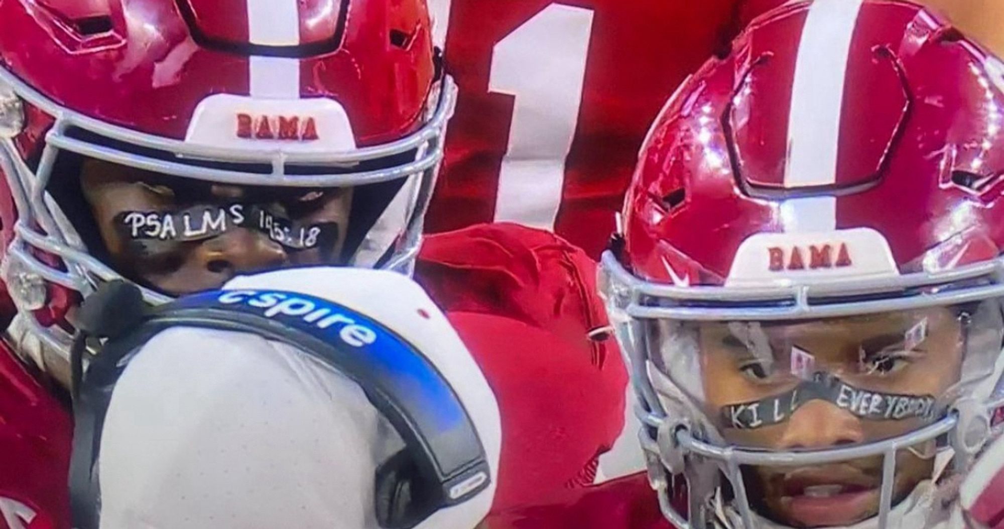 two alabama football players 

one has tape over his nose with a psalms verse, the other has tape over his nose that says kill everybody