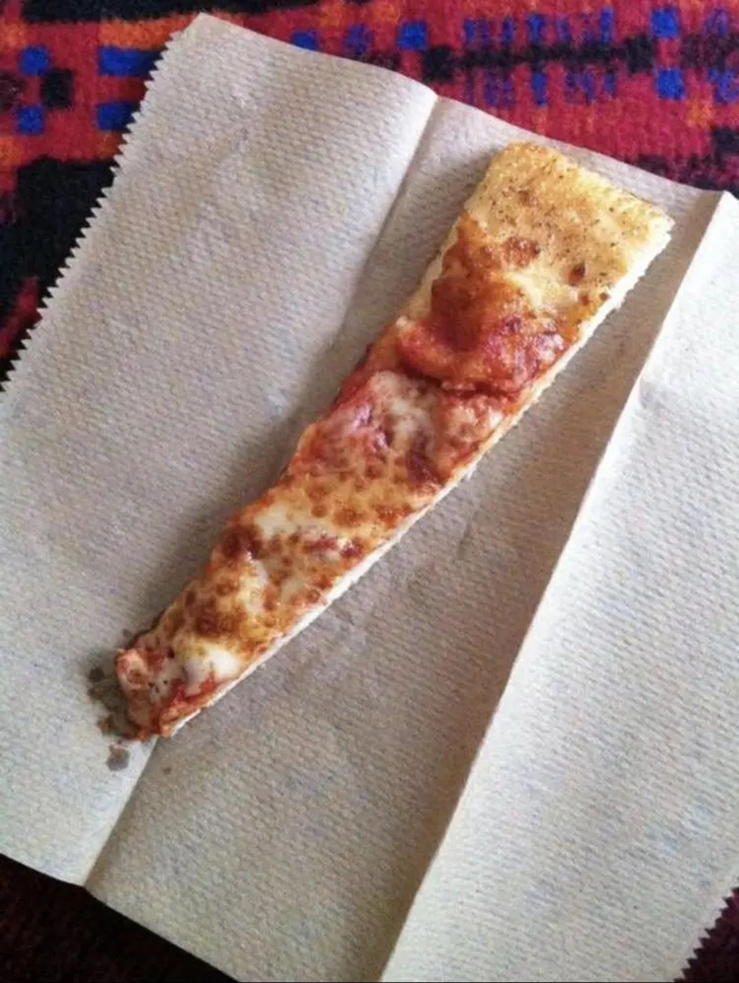 A very tiny slice of pizza