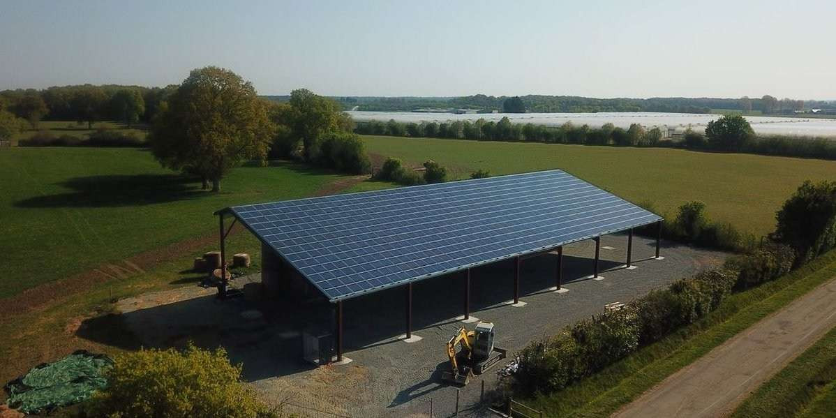 Storage shed with solar panel roof in farm field