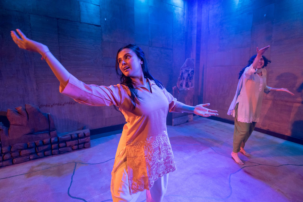 two female performers in blue lighting