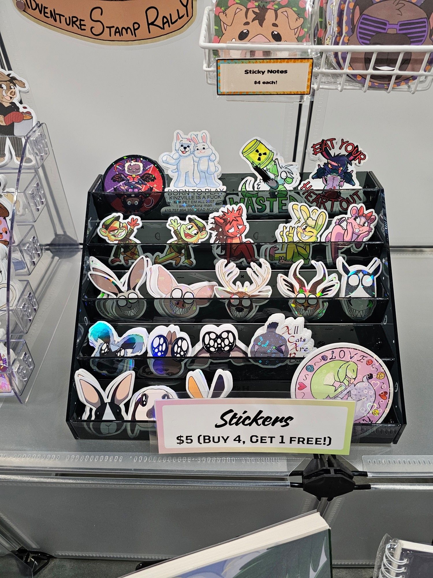 A display rack filled with stickers of happy tree friend characters, webkinz, grinning beasts and more!