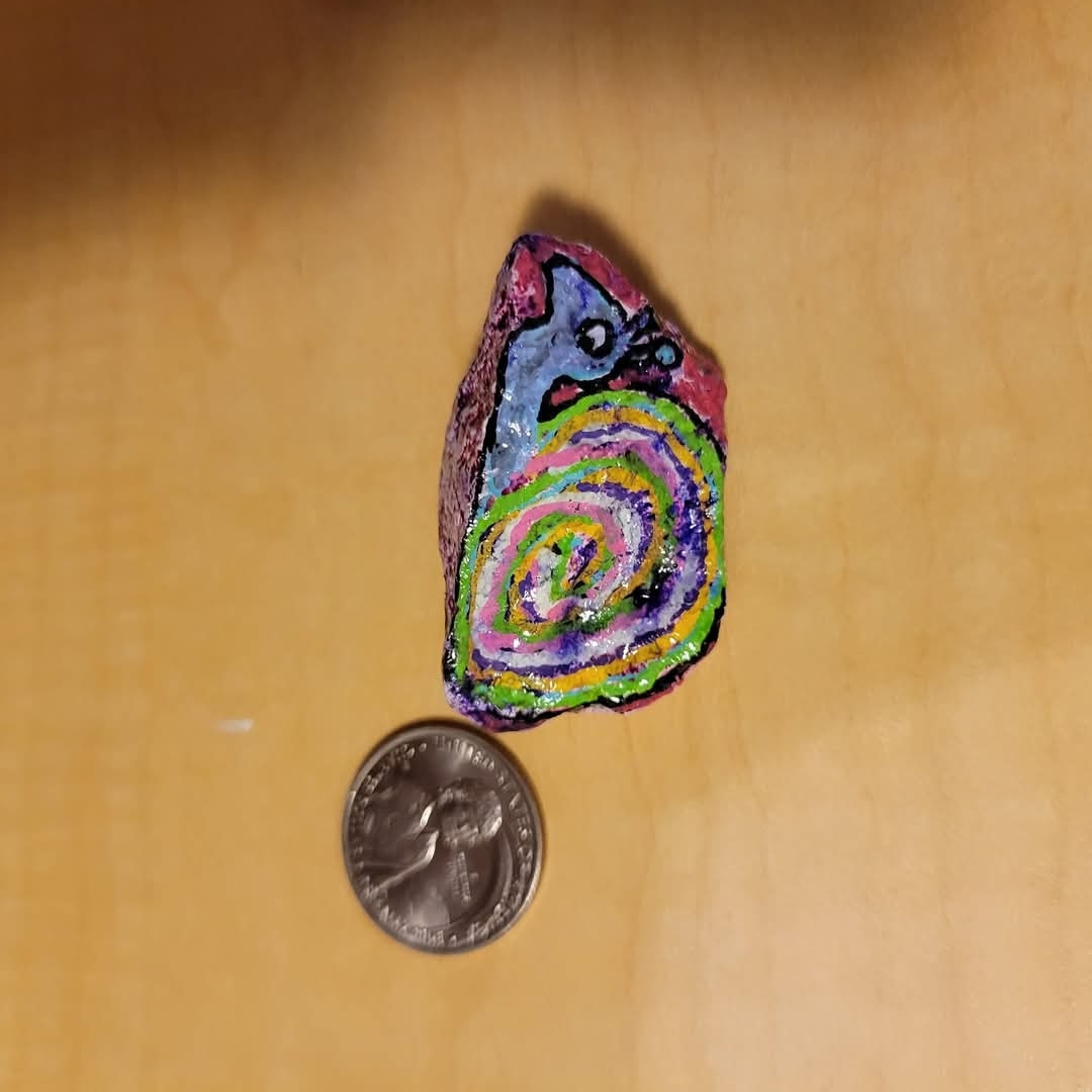 You can tell that it's a snail this time because there aren't any feet. Also the shell has a multicolored swirl instead of  irregular pieces. 