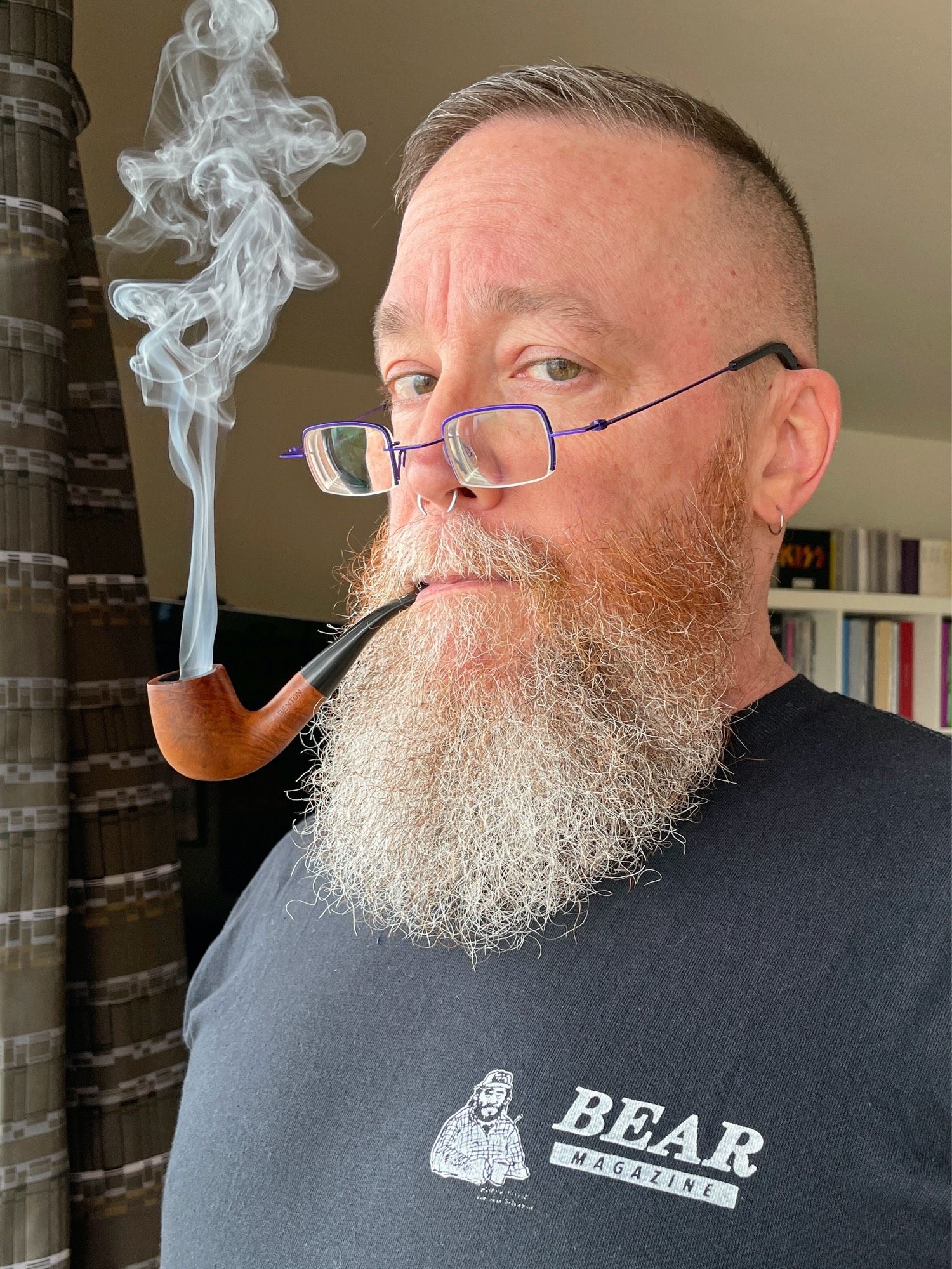 Wearing a repro vintage Bear Magazine t-shirt and smoking my pipe as I look over the top of my glasses in a very judge-y dad kinda way - this time in color.