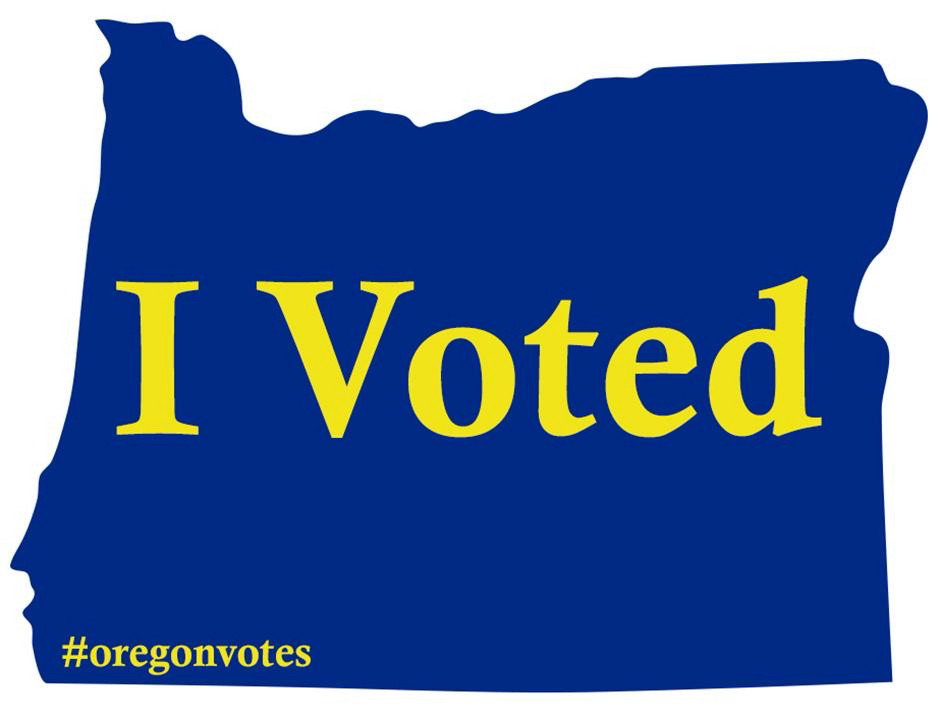 An “I Voted” ‘sticker’, lettering in gold, against a blue silhouette of the state of Oregon. The hashtag “oregonvotes” in the lower left.