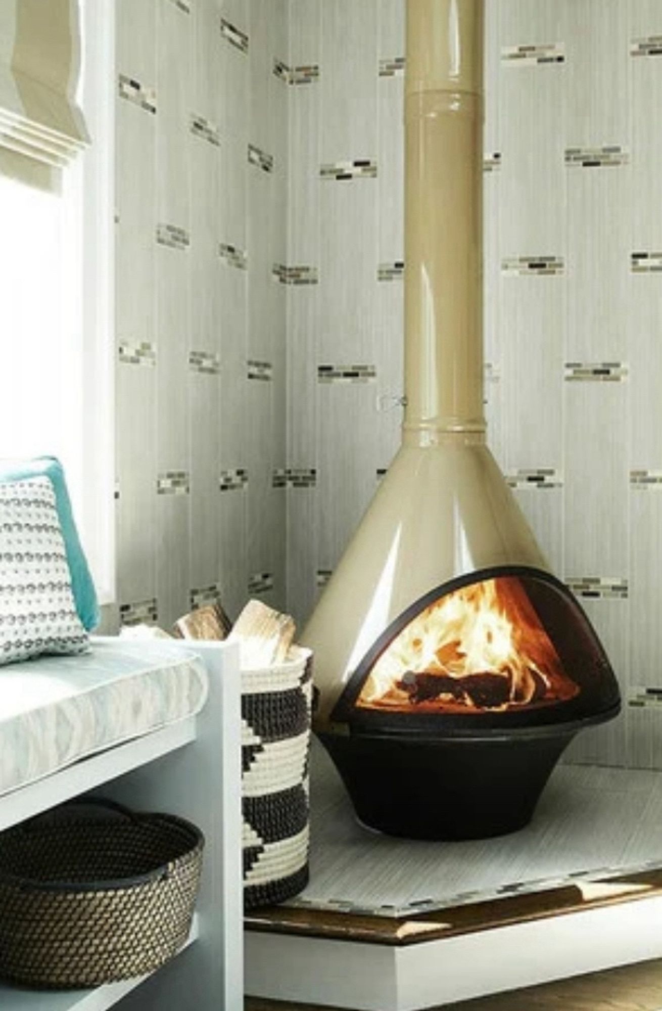 A cream colored MCM triangular fireplace, clearly a new one, not an actual old cool one