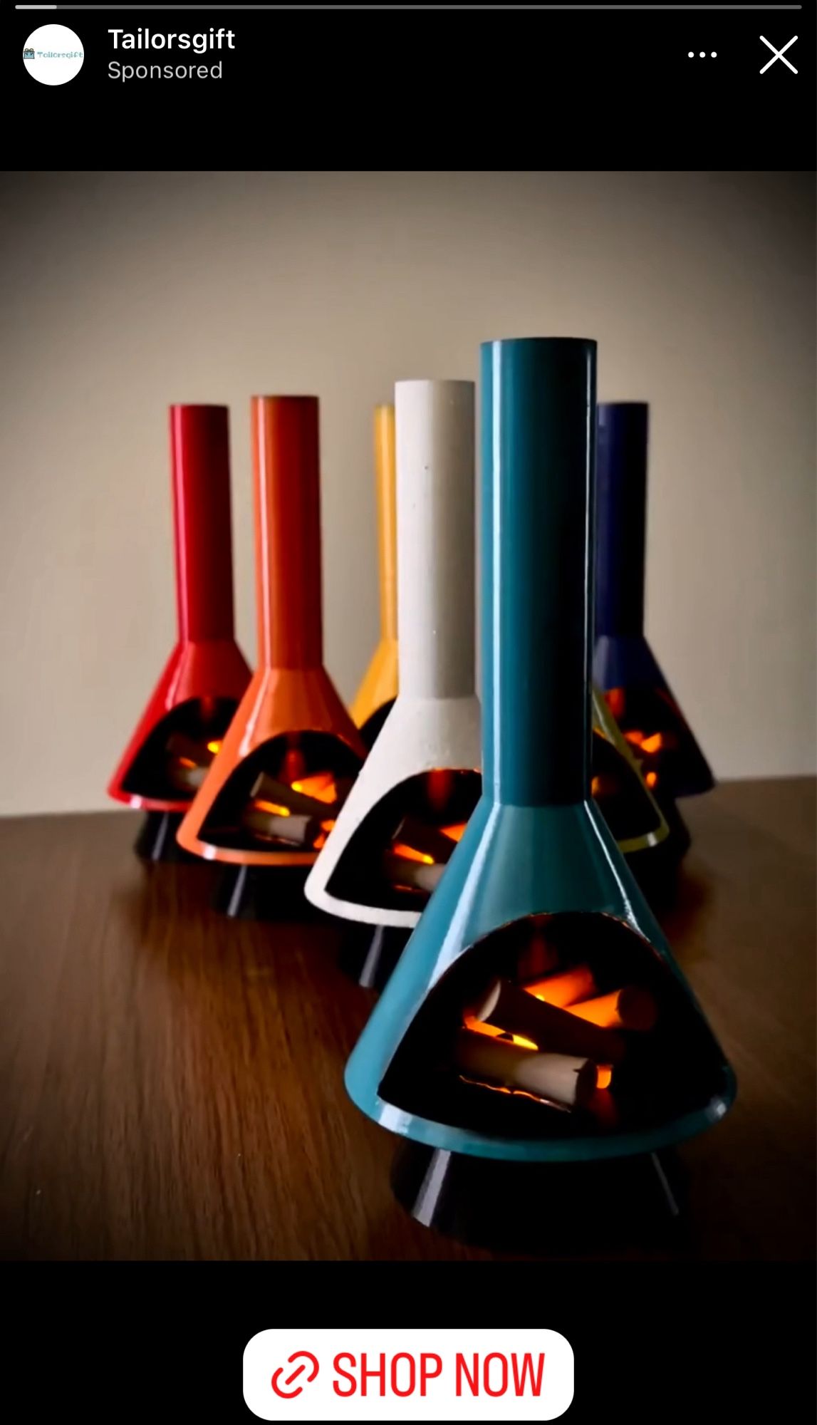 An Instagram ad for mini mid-century style triangular floor-to-ceiling fireplaces in nice bright colors like teal, yellow, red, and orange