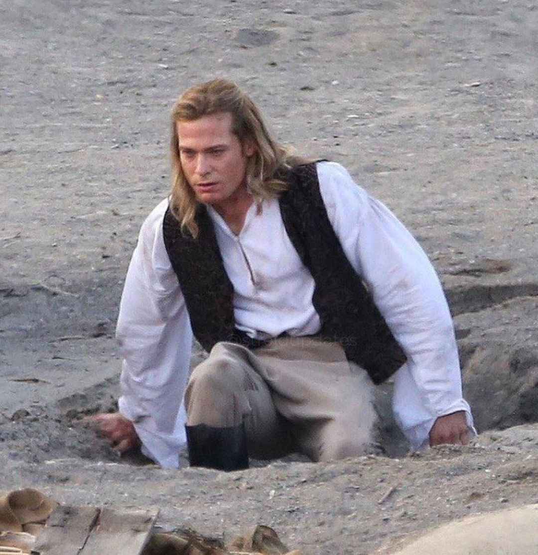 lestat morosely crawling out of some sand 
