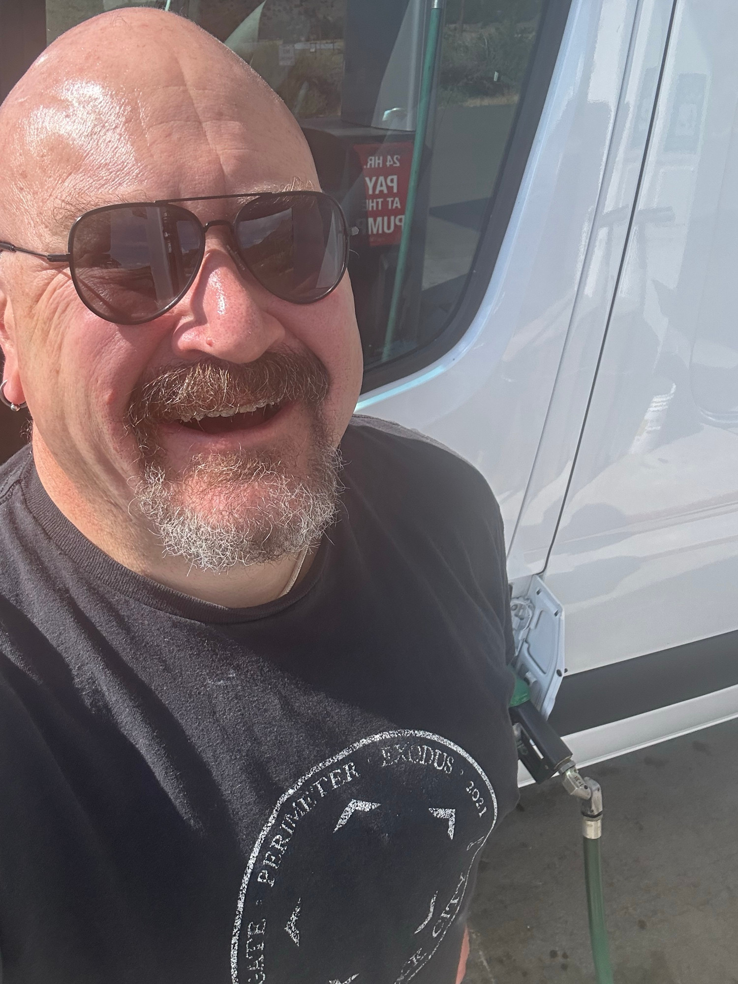 Me smiling while pumping gas at
Rabbit Traxx, with my head shaved for the first time since 2020. 