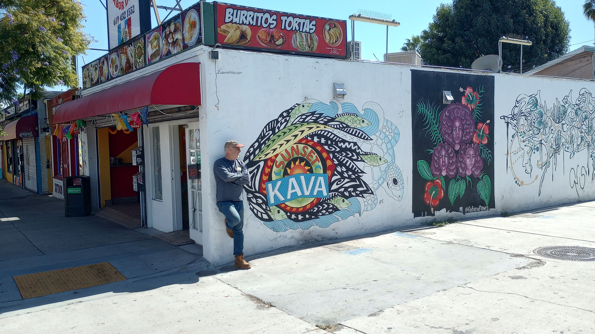 Picture of a taco shop, one wall adorned with street art