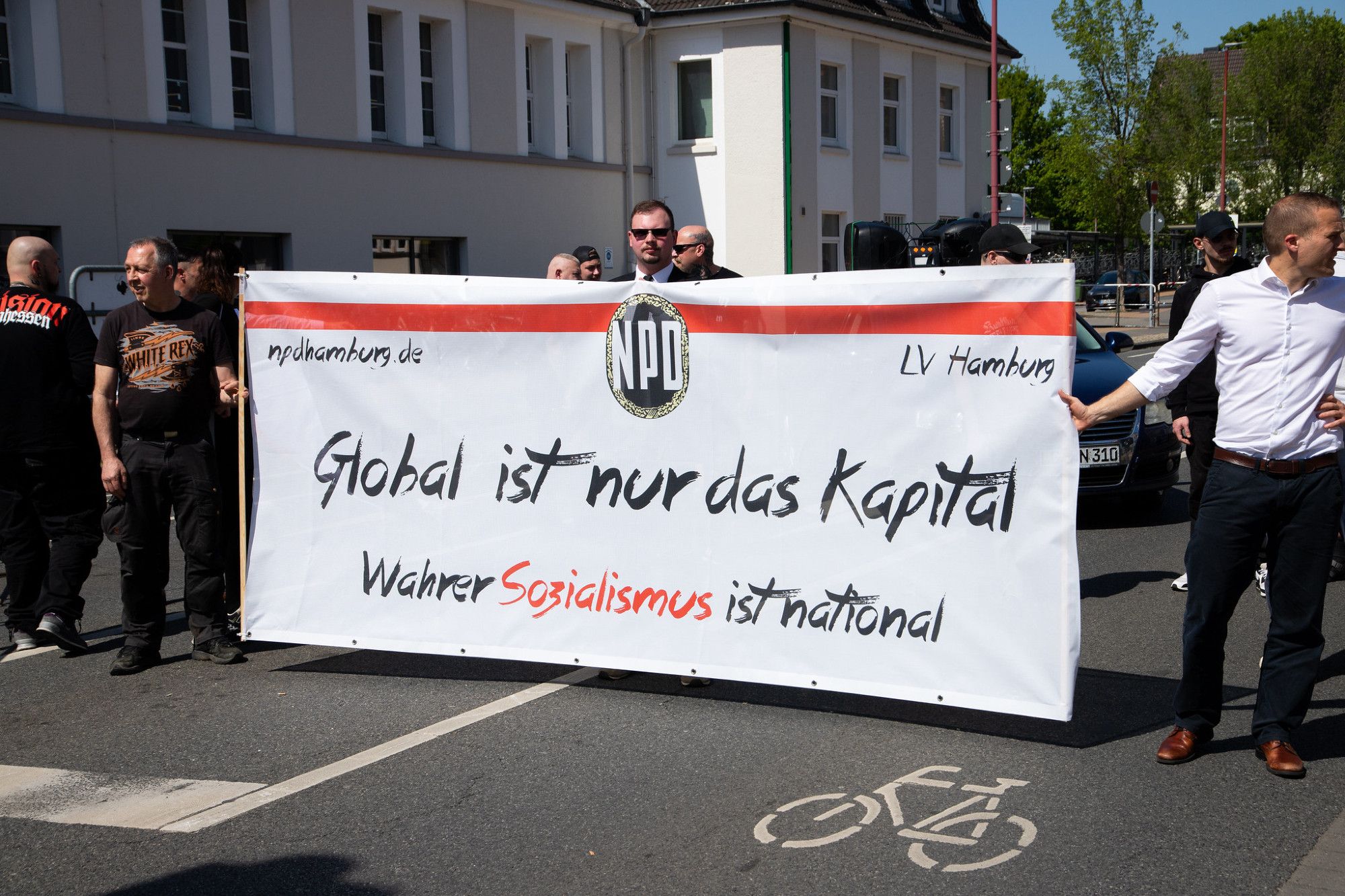 Mehrere Neonazis stehen hinter einen Trasparent auf dem "npdhamburg.de LV Hamburg. Global ist nur das Kapital - Wahrer Sozialismus ist national" steht