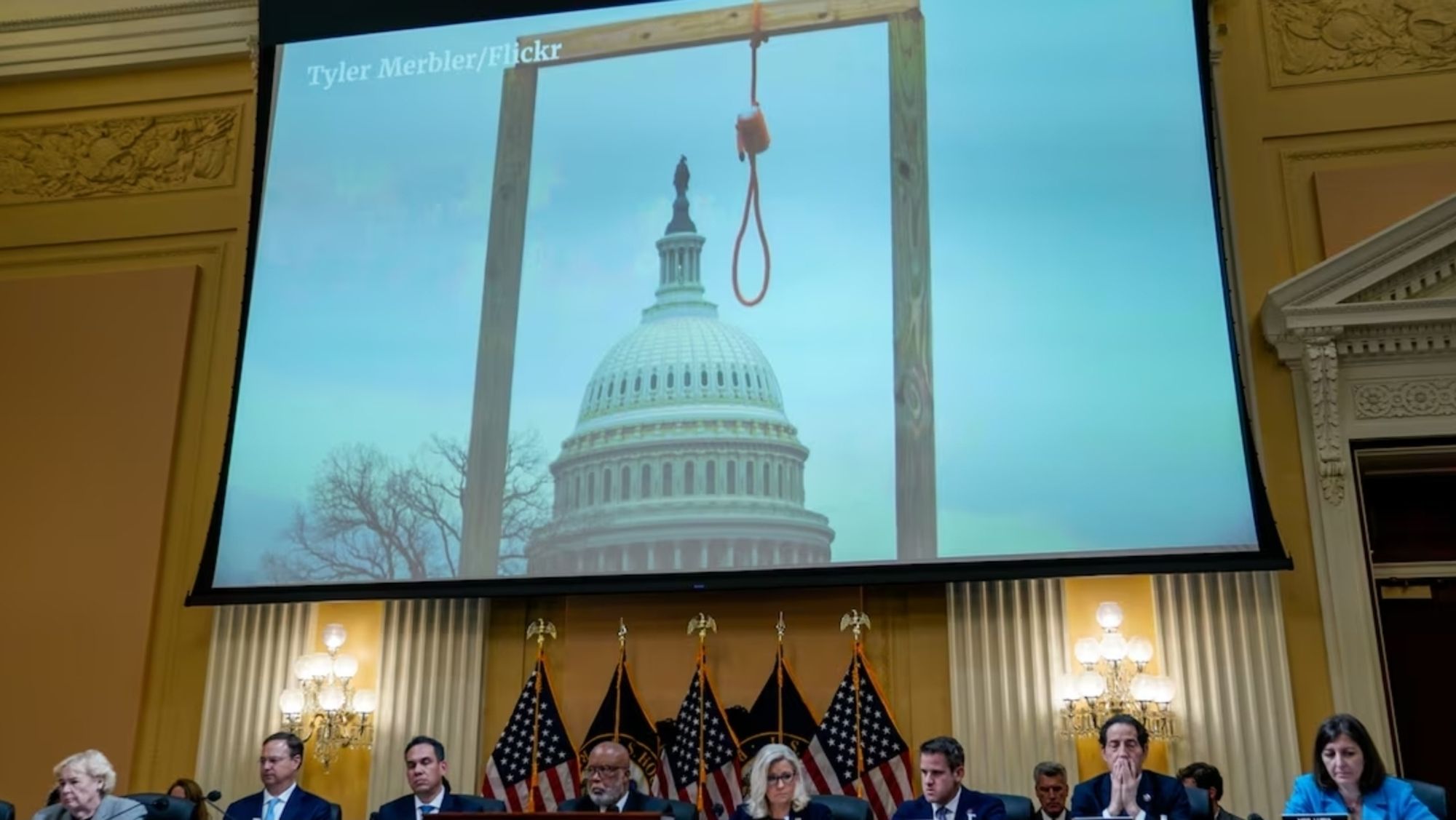 Photo of gallows on screen above January 6 committee in the Capitol.