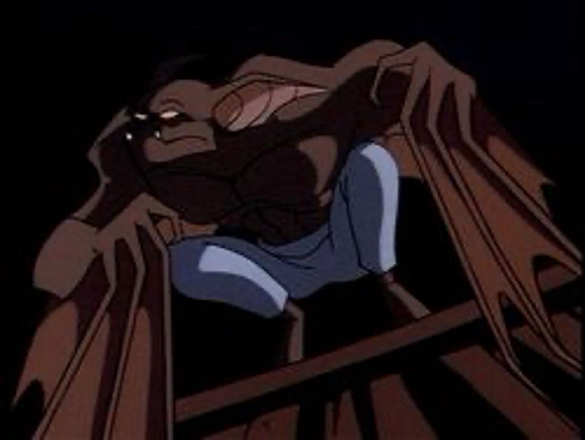 A giant man and bat hybrid with a muscular chest. He’s wearing pants and no shoes and looks sad.