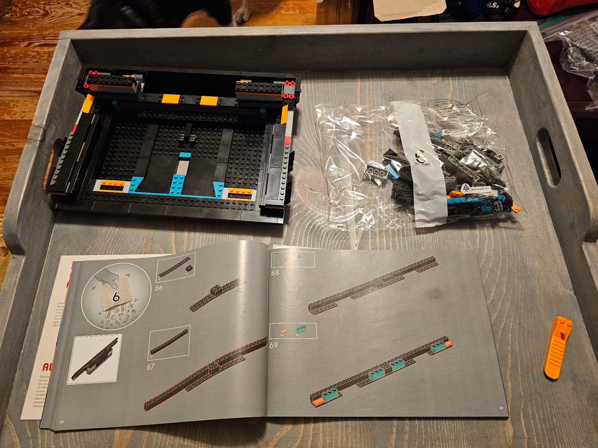 A partially completed Lego Atari sits on a tray. The instructions and next bag ready for the next steps.