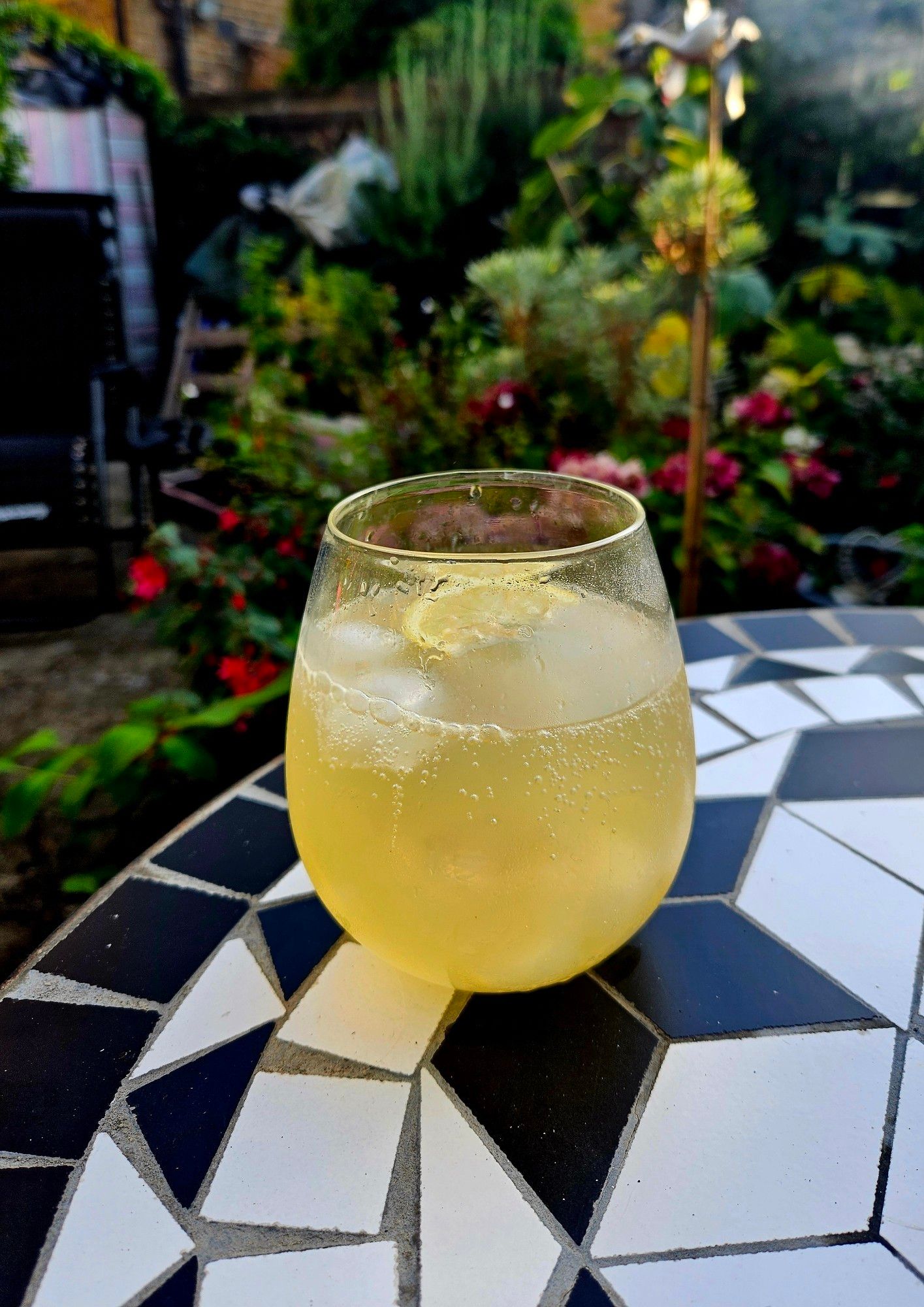 Glass of limoncello spritz on garden table