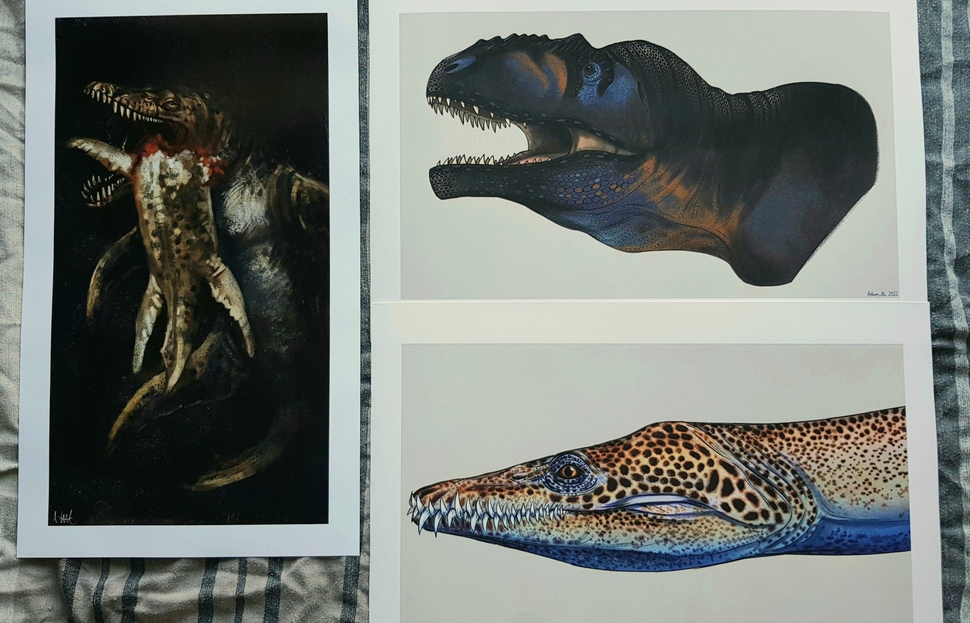 From left-to-right: The titan Cronus (Kronosaurus) devouring one of his kin, Giganotosaurus portrait, Rhomaleosaurus portrait.