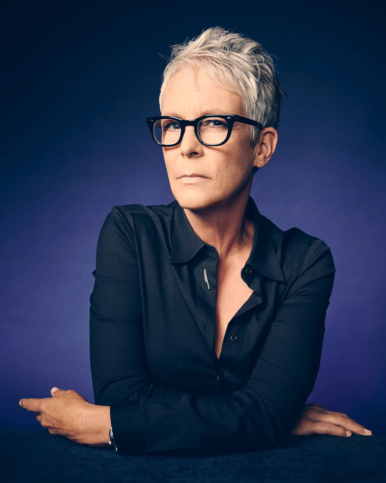 Jamie Lee Curtis black shirt glasses short grey hair. arms folded and frowning. blue background. hot.

"So, take what's inside you and make big, bold choices and for those who can't speak for themselves, use bold voices and make friends and love well, bring art to this place and make the world better for the whole human race."