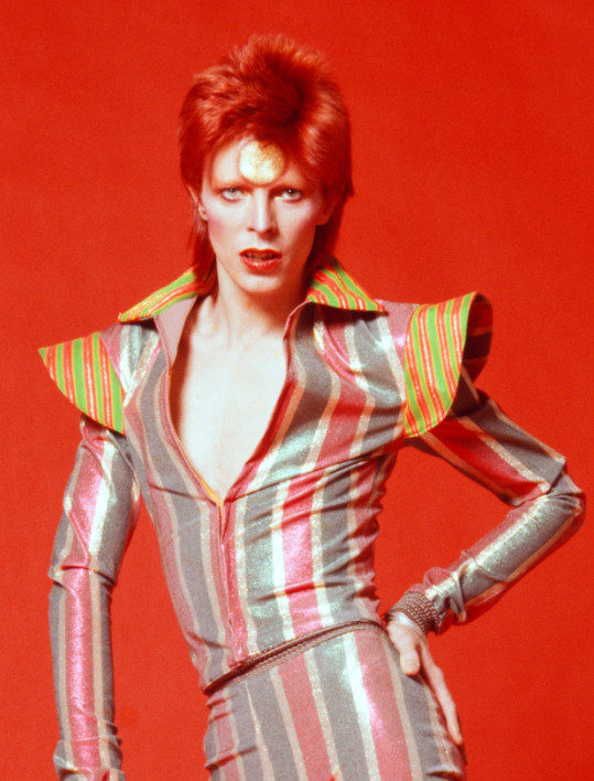 David Bowie in a grey pink and white striped unitard of sorts with big orange and lime green shoulder pads and collar. red hair and lipstick red background hand on hip. hot.

"Questioning my spiritual life has always been germane to what I was writing. Always. It's because I'm not quite an atheist and it worries me. There's that little bit that holds on: 'Well, I'm almost an atheist. Give me a couple of months.'"