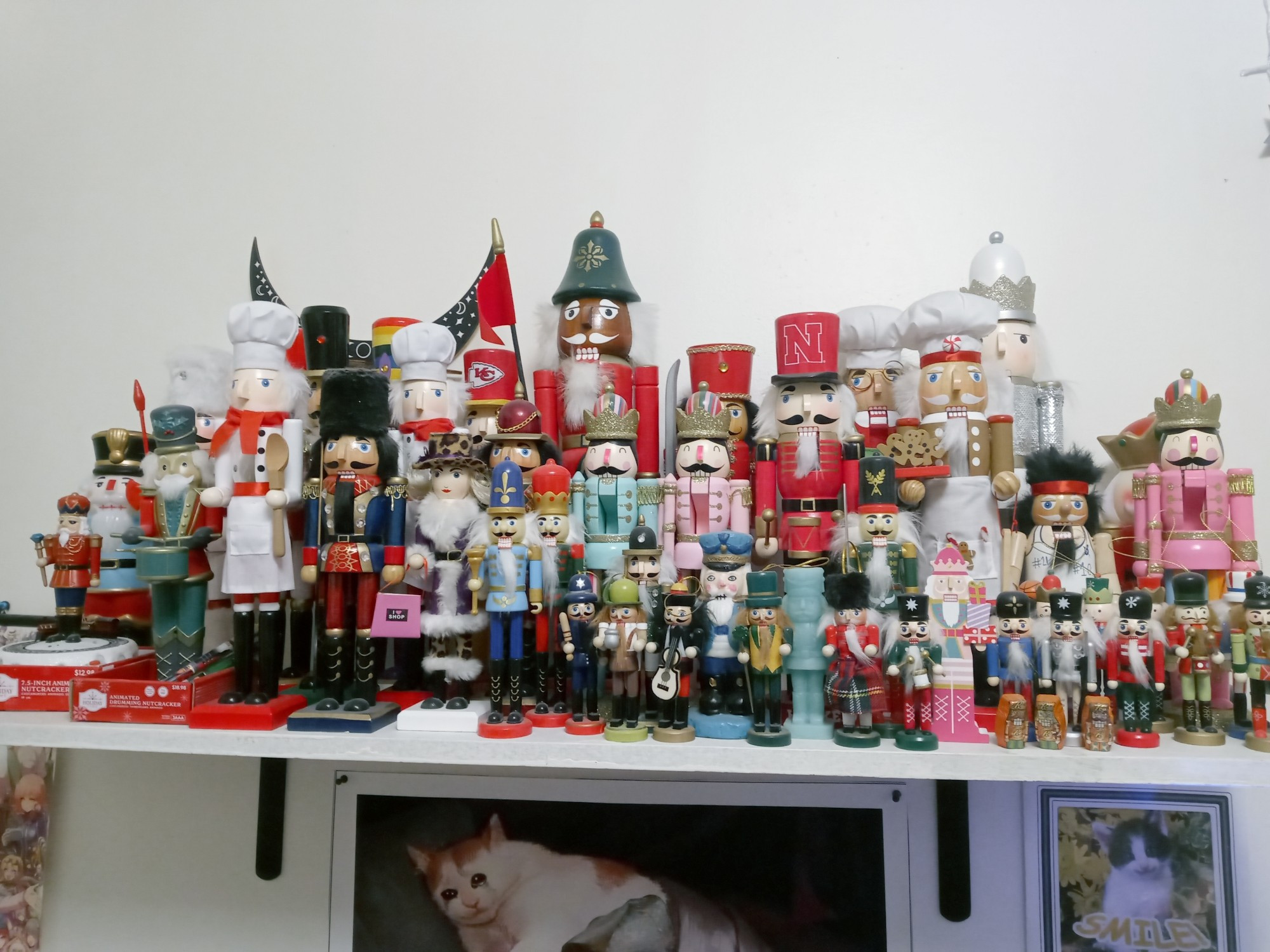 Picture of my nutcracker collection on a shelf on my wall. Many large nutcrackers as well as a good amount of small ones, lamps, and other nutcracker-related stuff.