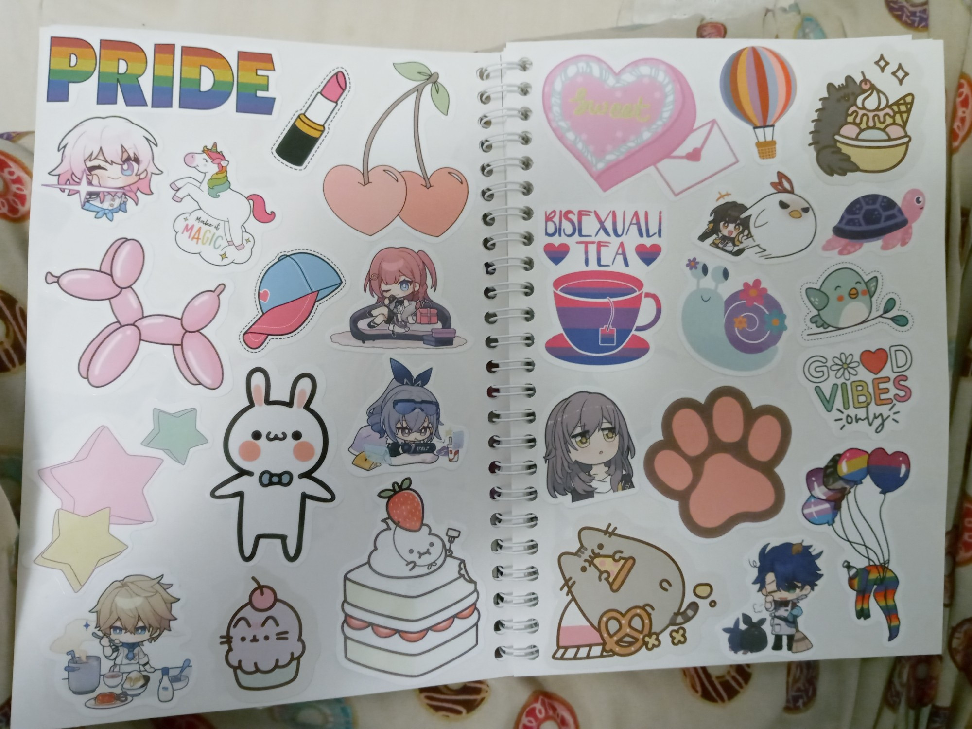 2 pages of my sticker book, which includes pride, Honkai Star Rail, Pusheen, and generally cute stickers.