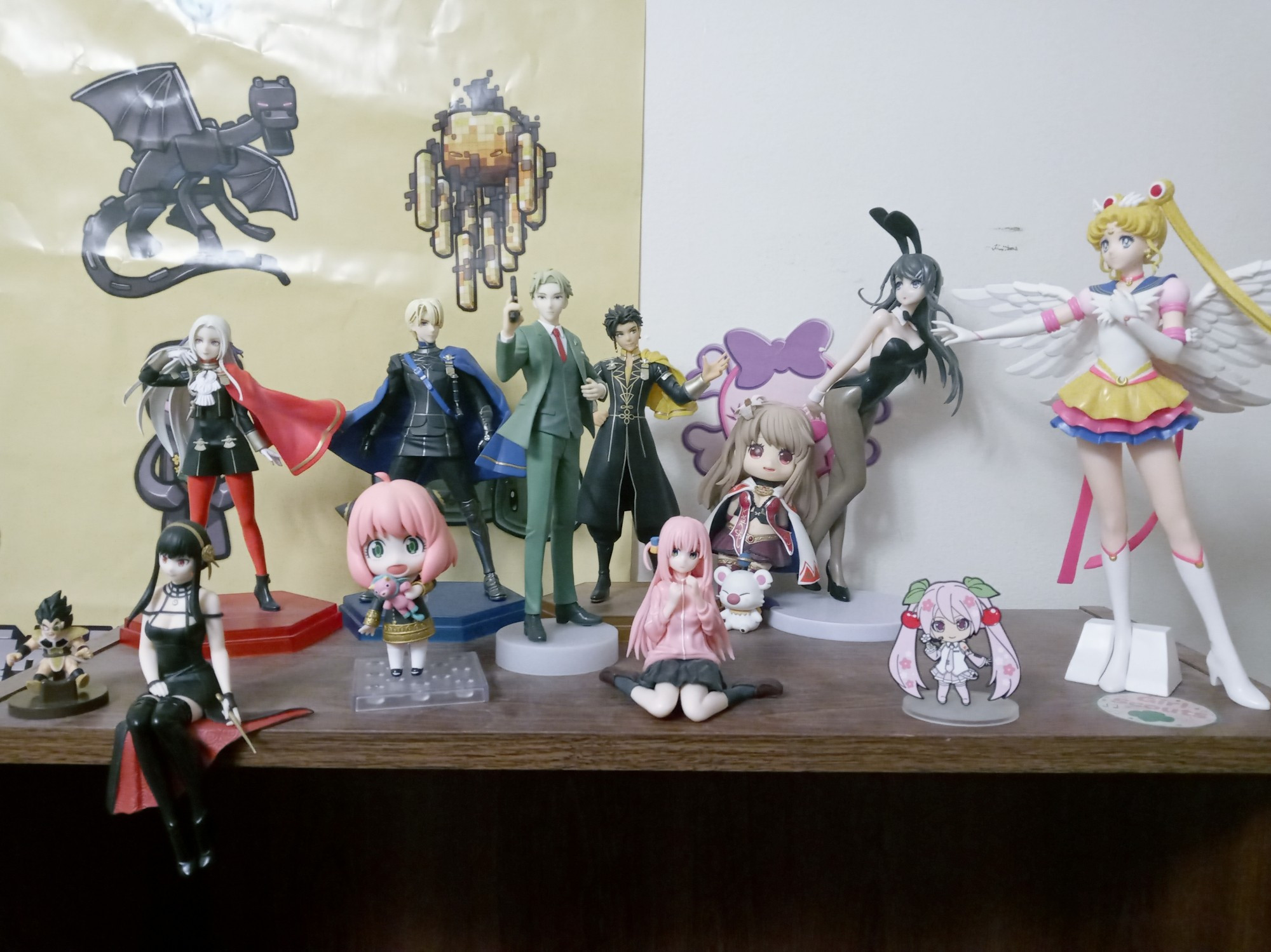 Picture of my figure collection. From left to right, front to back:
Front: Raditz (Dragon Ball), Yor (Spy x Family), Anya (Spy x Family), Loid (Spy x Family), Hitori Gotoh (Bocchi the Rock), Hatsune Miku (Sakura Variant, Vocaloid, technically a pin but she has a stand so that's fine), Usagi/Sailor Moon (Sailor Moon)
Back: Edelgard (Fire Emblem Three Houses), Dimitri (Fire Emblem Three Houses), Claude (Fire Emblem Three Houses), Fina and a Moogle (Final Fantasy Brave Exvius), and Mai (Rascal Does Not Dream of Bunny Girl Senpai)