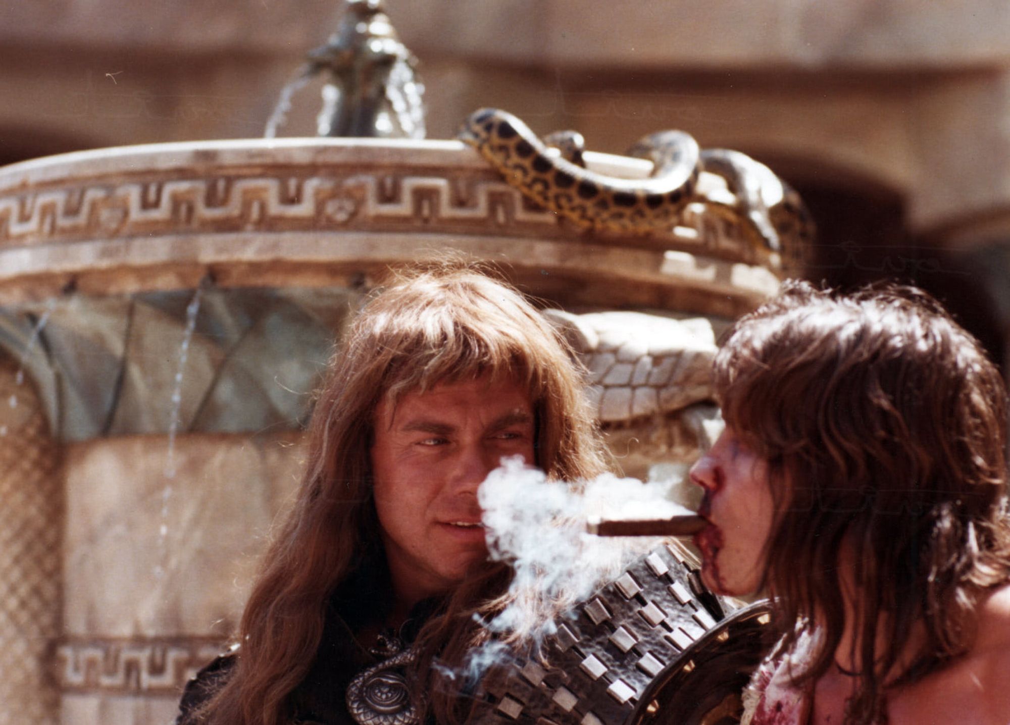 Arnold blows the smoke of his cigar in the face of Sven-Ole Thorsen near Cueva de Roque in Almeria