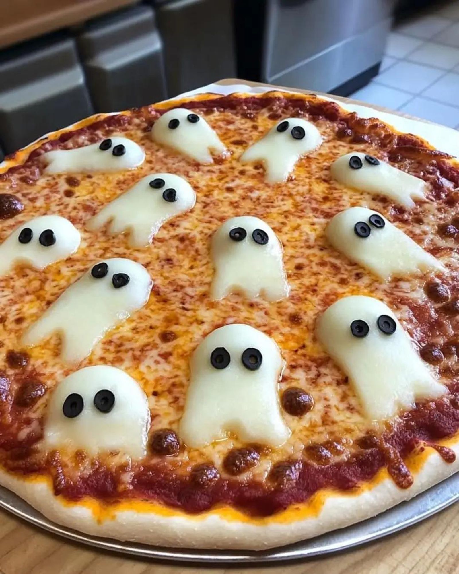 Pizza with "ghost" toppings made from black olives and white cheese