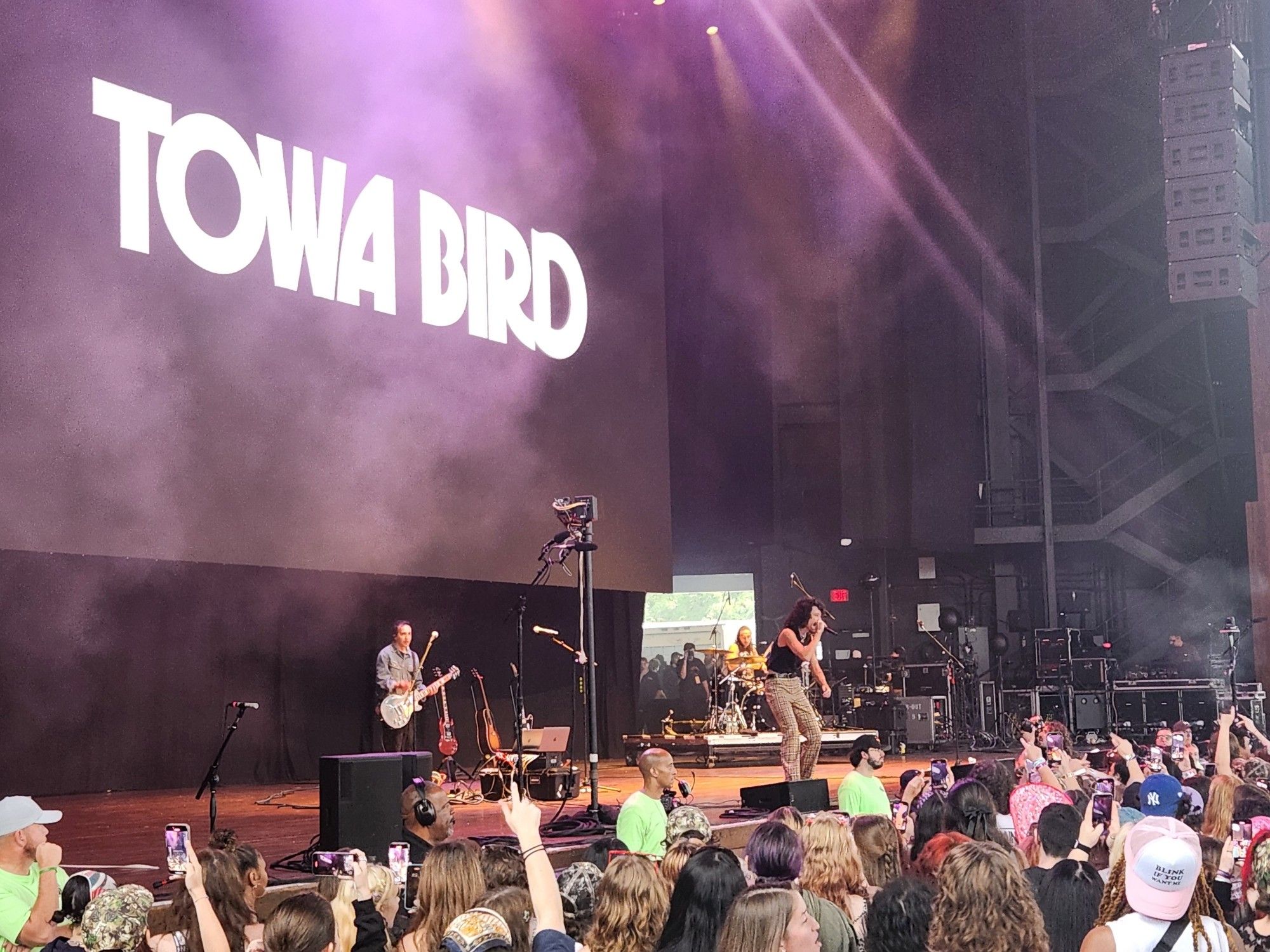 Music band Towa Bird performing on stage in front of crowd.