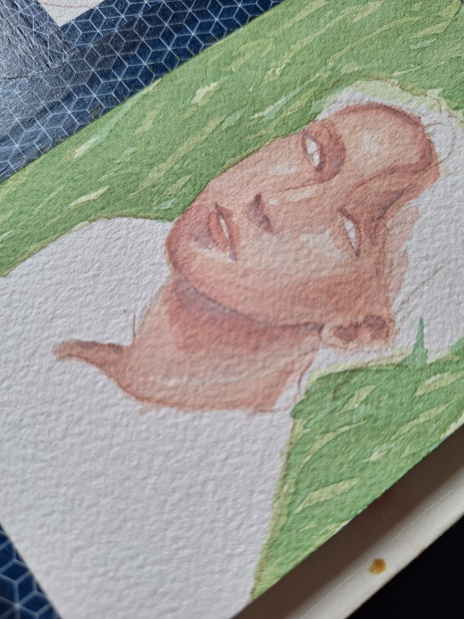 A work in progress of a watercolor portrait of a man, with only the skin painted and a green background