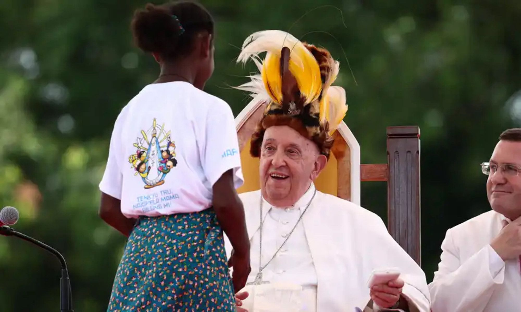 Pope Francis in traditional Papuan headgear, welcoming a local child.