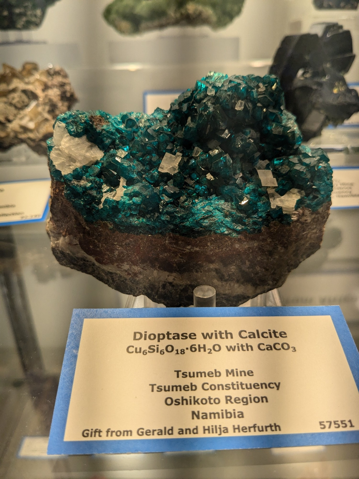 a cluster of cyan crystals called dioptase with calcite