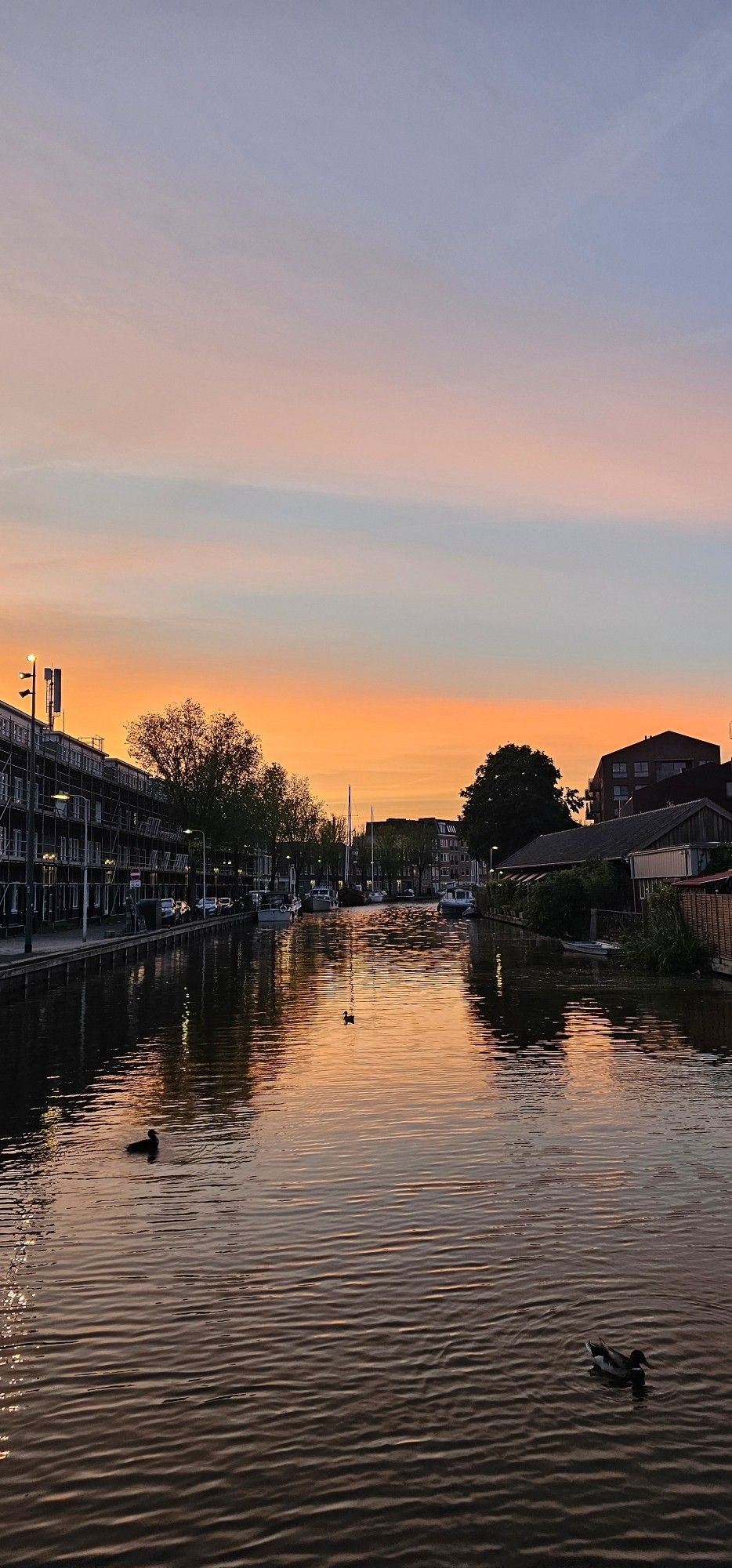 Oranjeblauwe lucht boven water met weerspiegeling