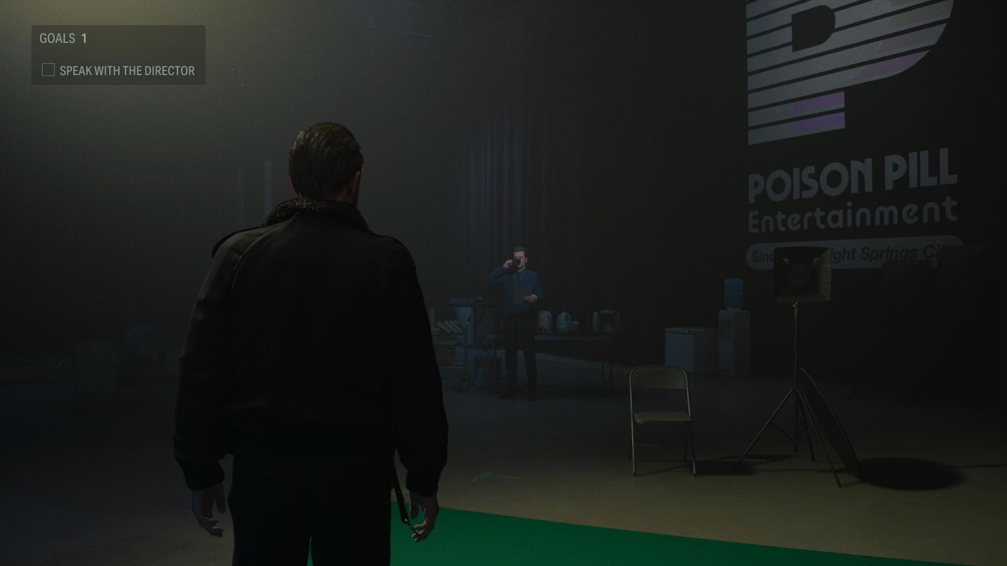 Screenshot of Alan Wake 2 Night Springs, shows The Actor on a moody set about to engage Sam Lake himself