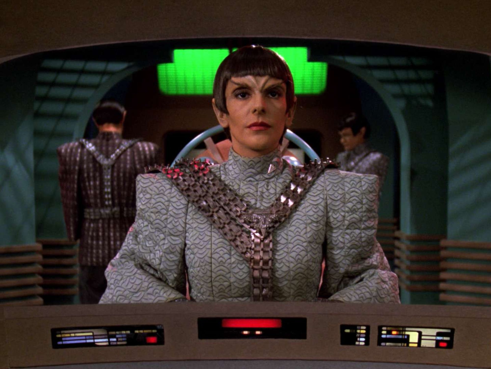 Troi on the view screen in Romulan makeup and uniform aboard a Warbird.