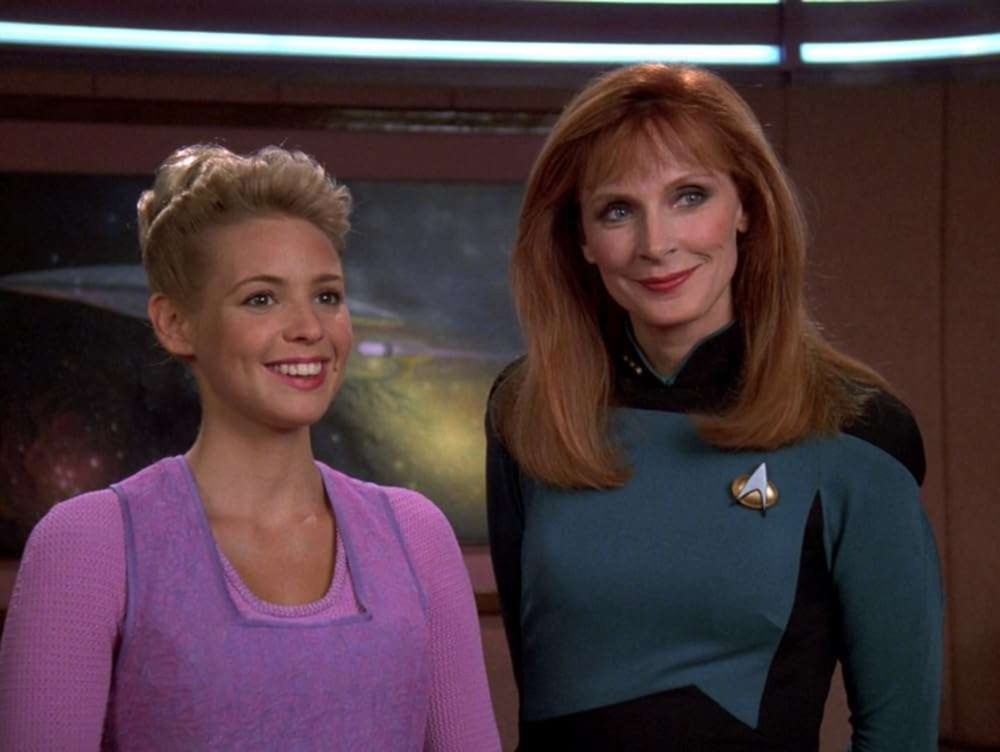 Amanda and Crusher, smiling in Picard's ready room.