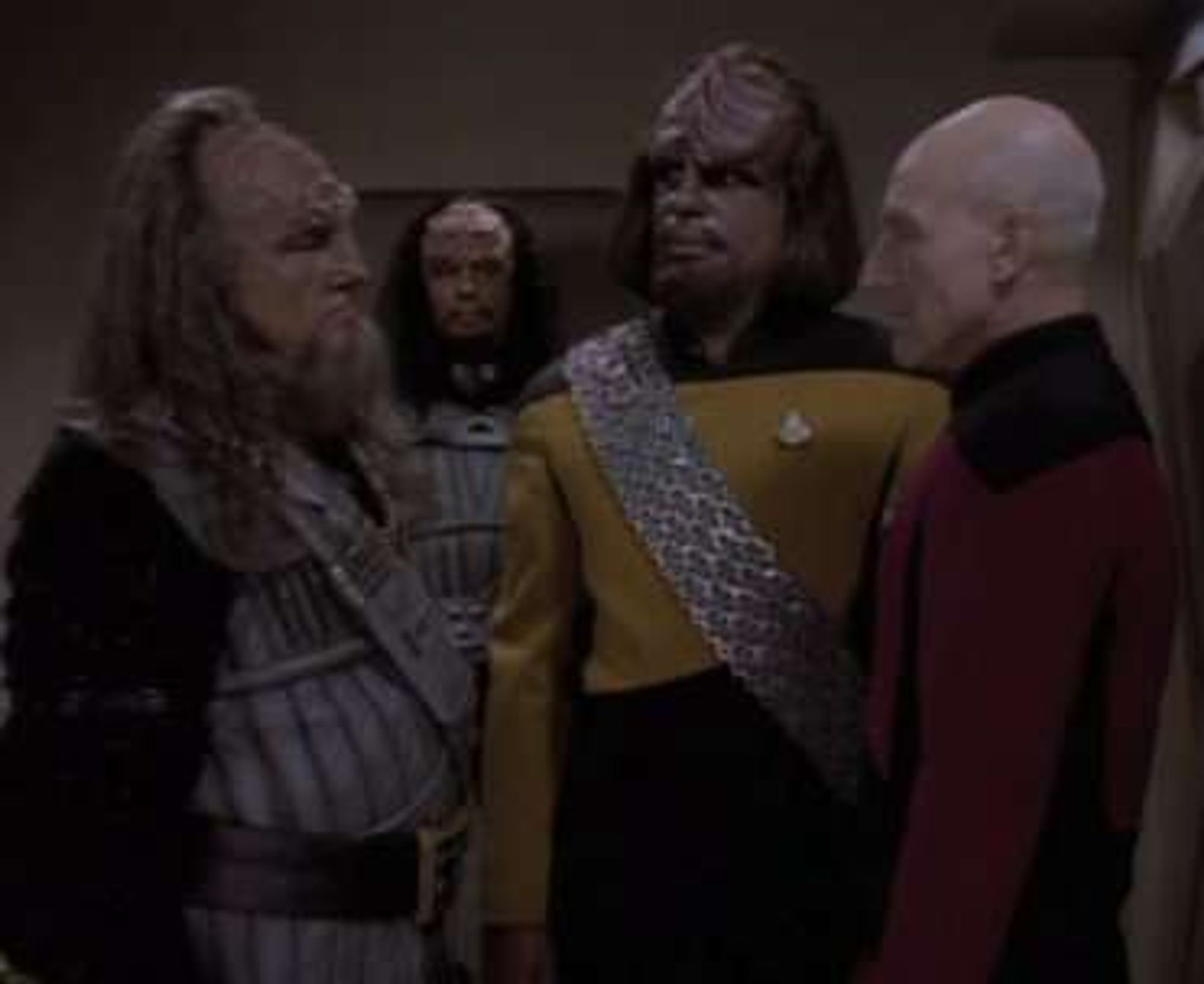 Klingons in uniform speaking to Worf and Picard on the Enterprise.