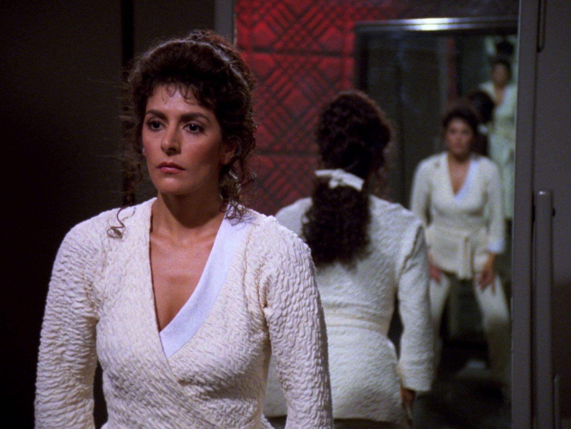 Troi looking at herself in the mirror doing Tai Chi.