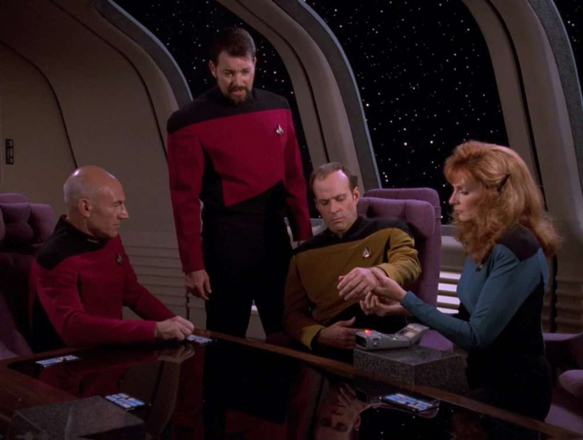 Barclay in conference room as Picard, Riker and Crusher look at his arm.