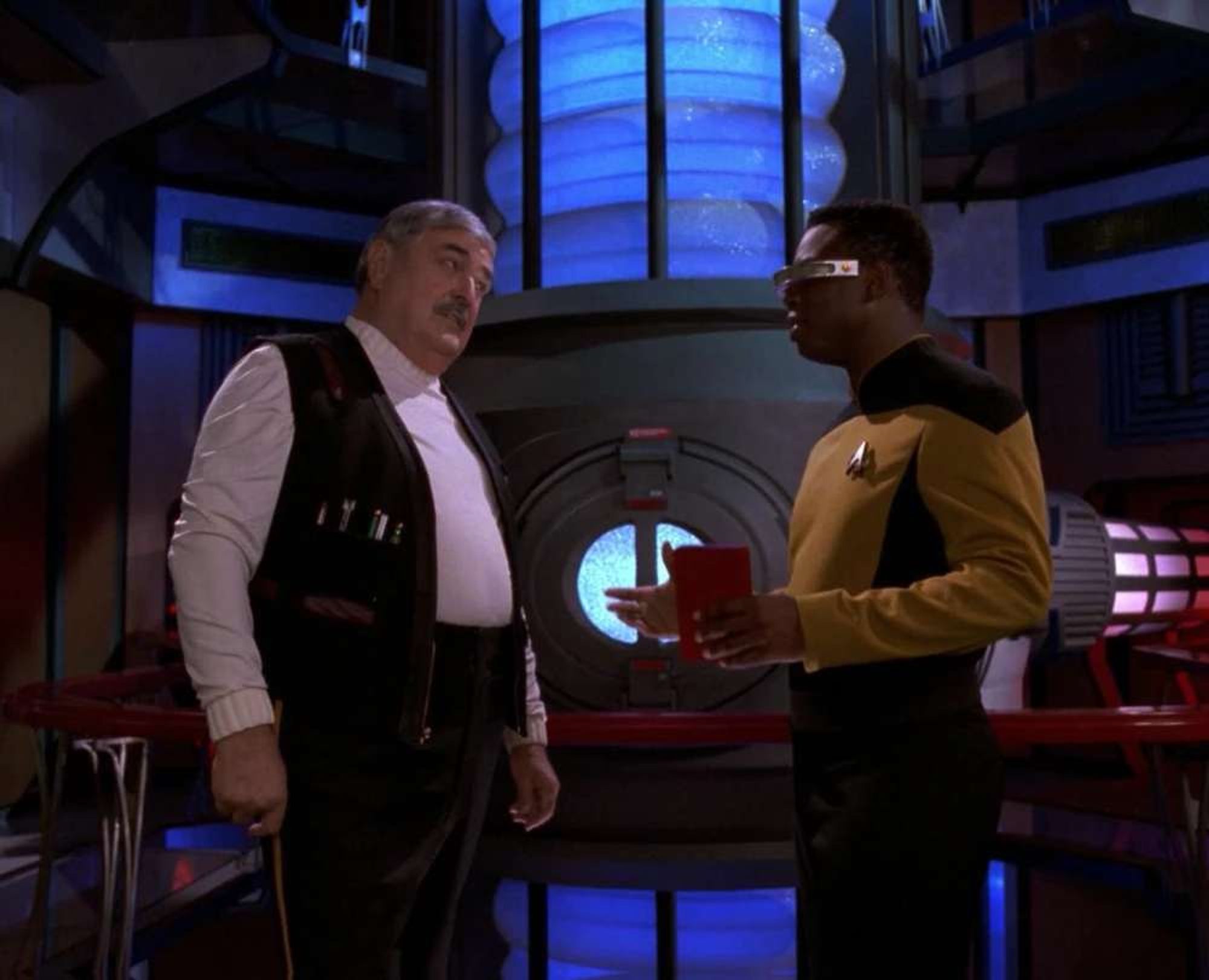 Scotty and Geordi in front of the WARP core in Engineering.