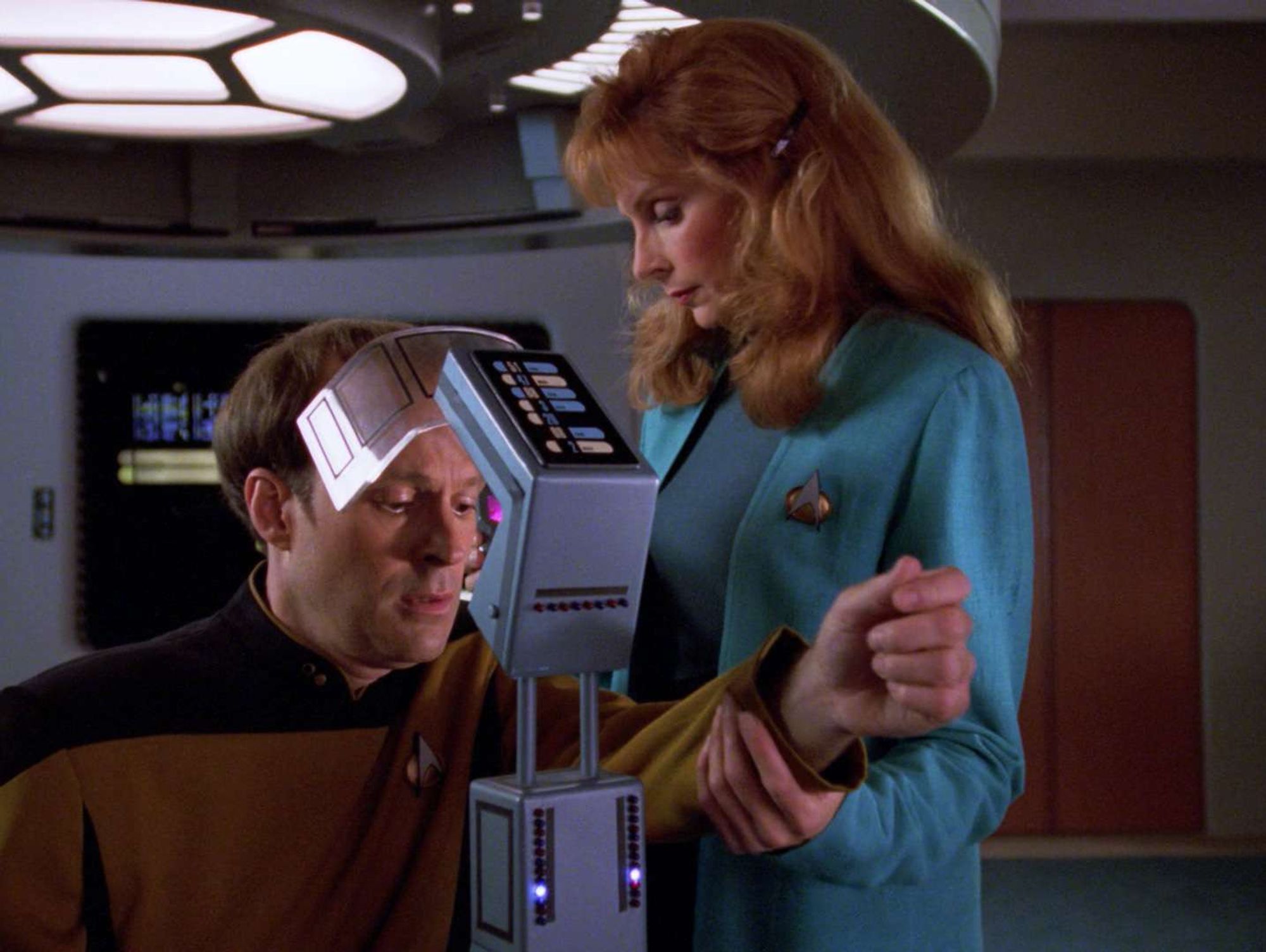 Barclay in sick bay apparatus being administered by Dr. Crusher.