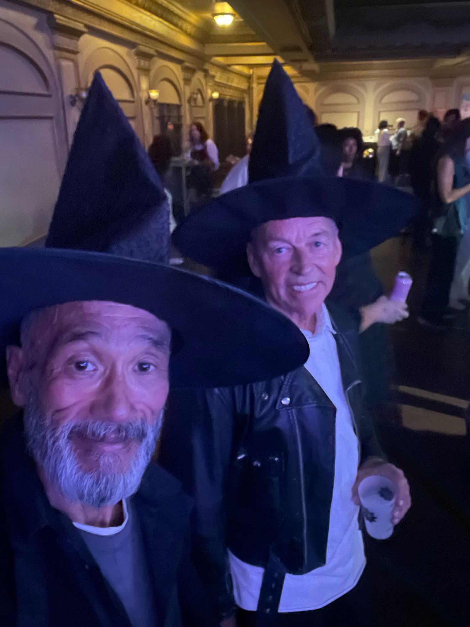 Husband and I dressed in black wearing witch’s hat