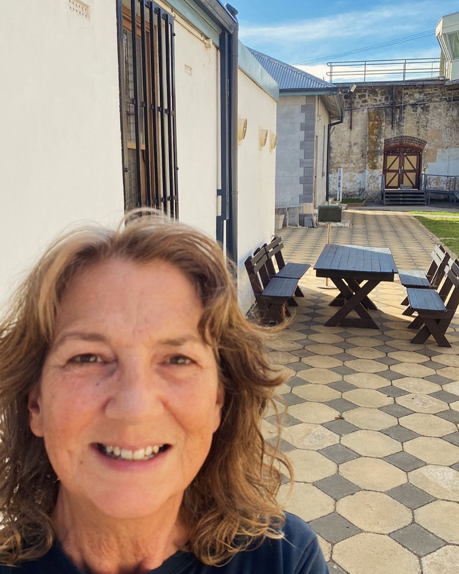 Bren on a paved area with wall, gate and watchtower in the background.