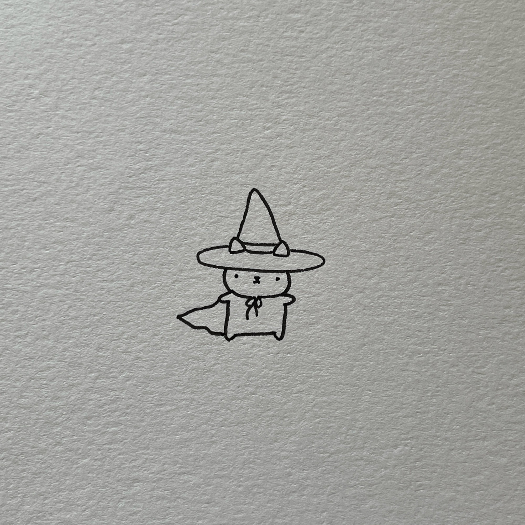 a poorly drawn cat wearing a witch costume (it’s casting some spells!)