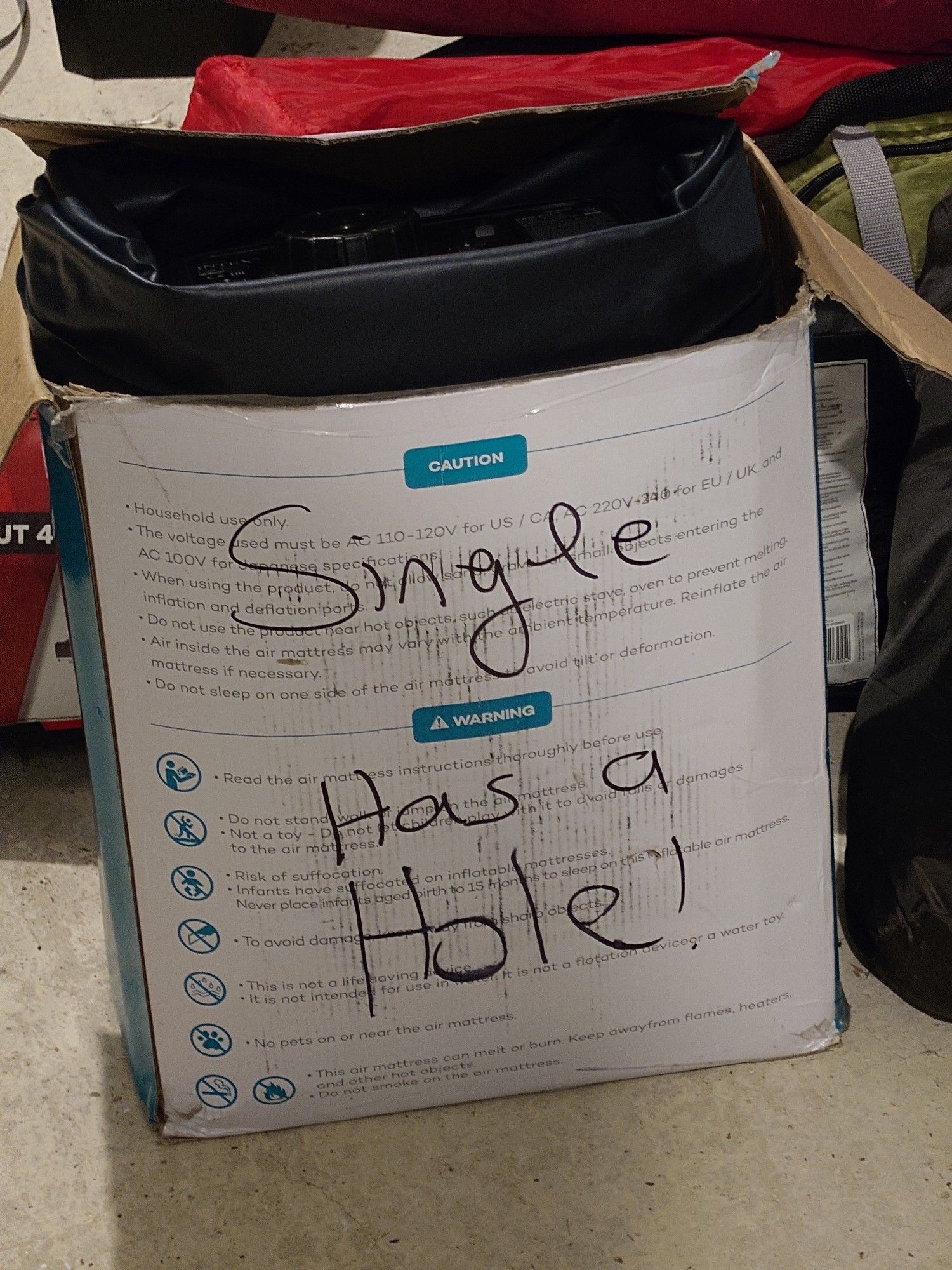 Inflatable mattress box labelled "Single, has a hole"