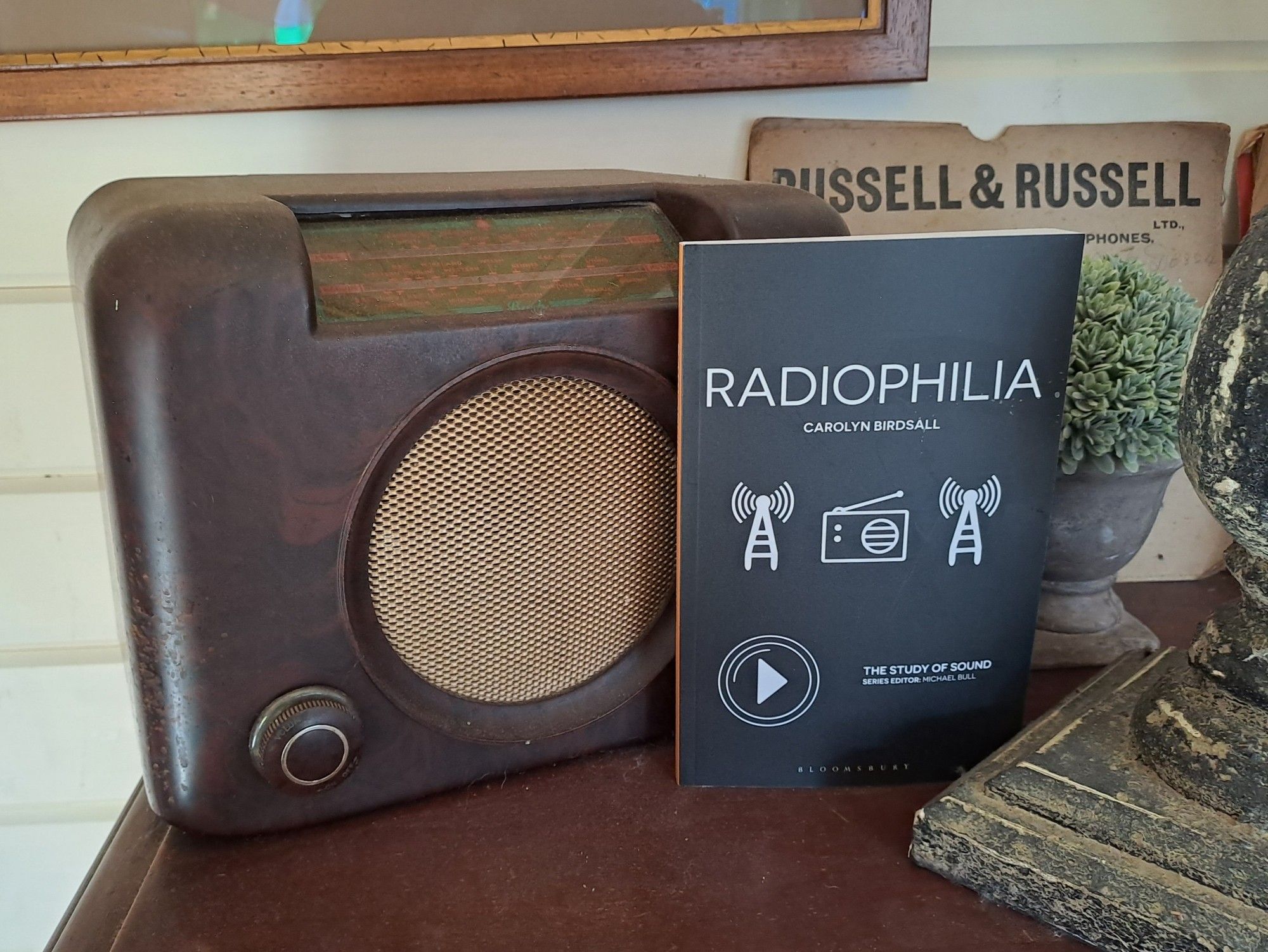 Copy of book called by Radiophilia by Carolyn Birdsall, leant against an old bakelite radio set.